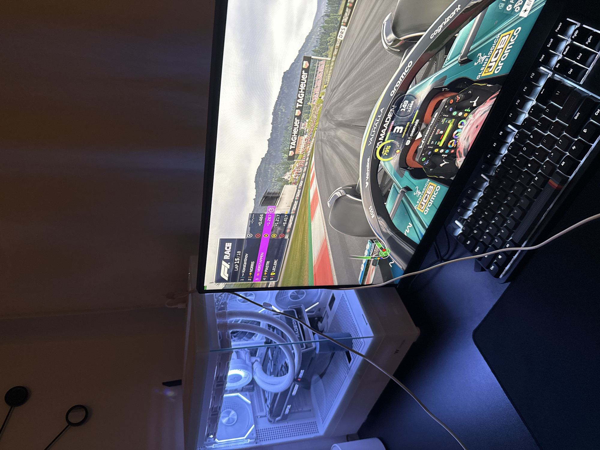 Gaming session: Formula 1 racing game played on illuminated PC