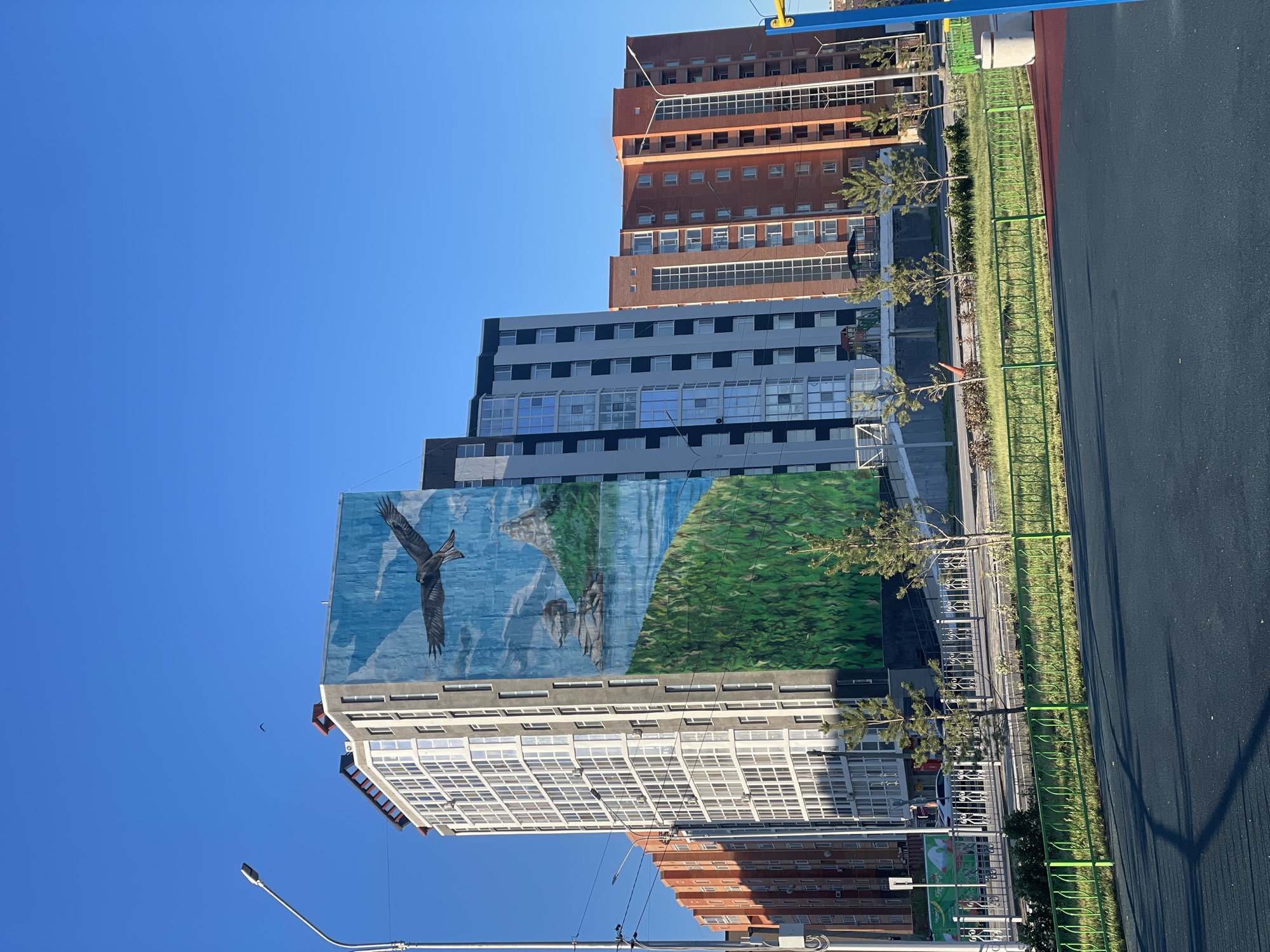 Multi-story buildings photographed under clear skies in Kokshetau