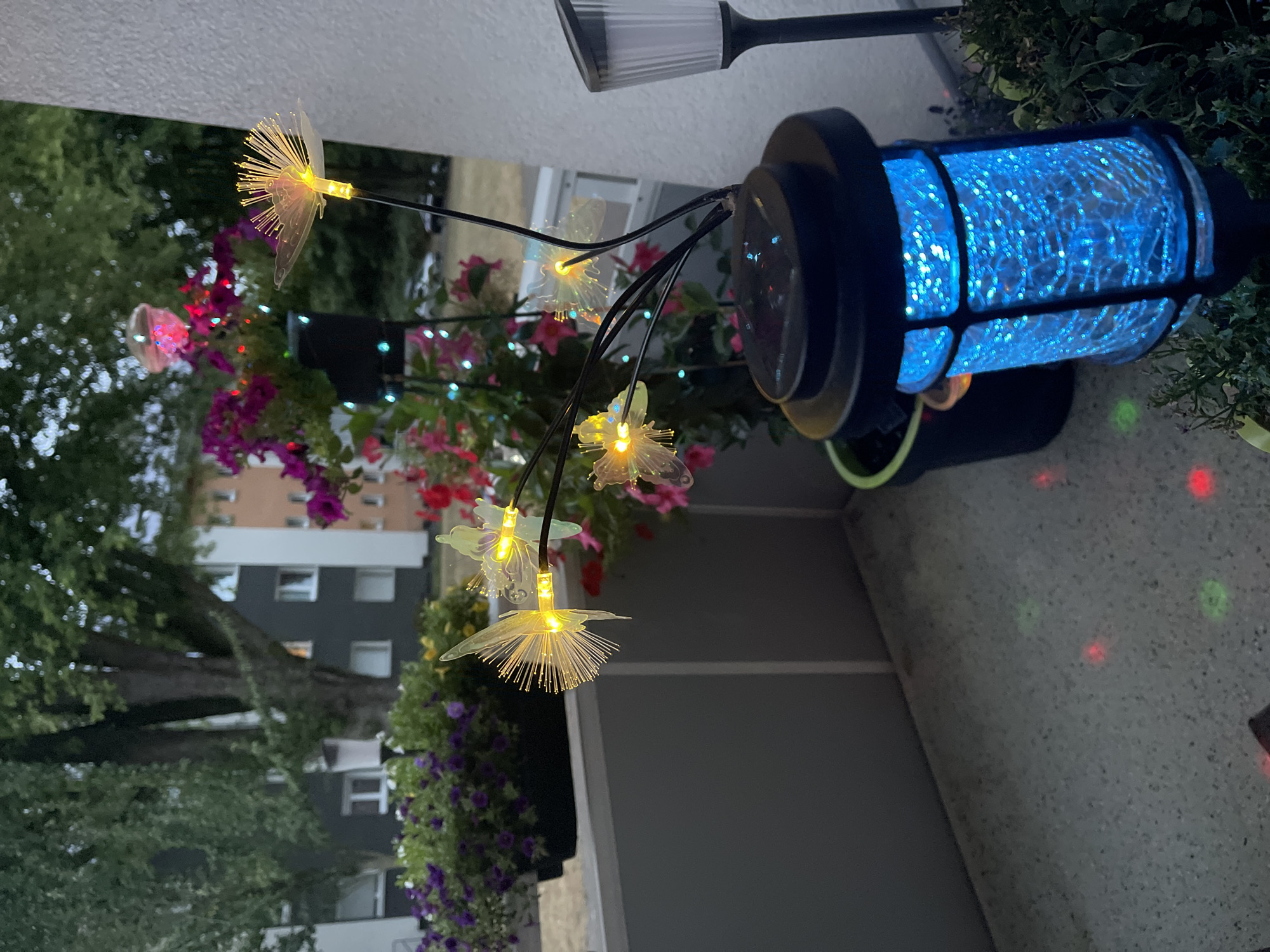 Balcony garden glows at dusk with petunias and solar lights