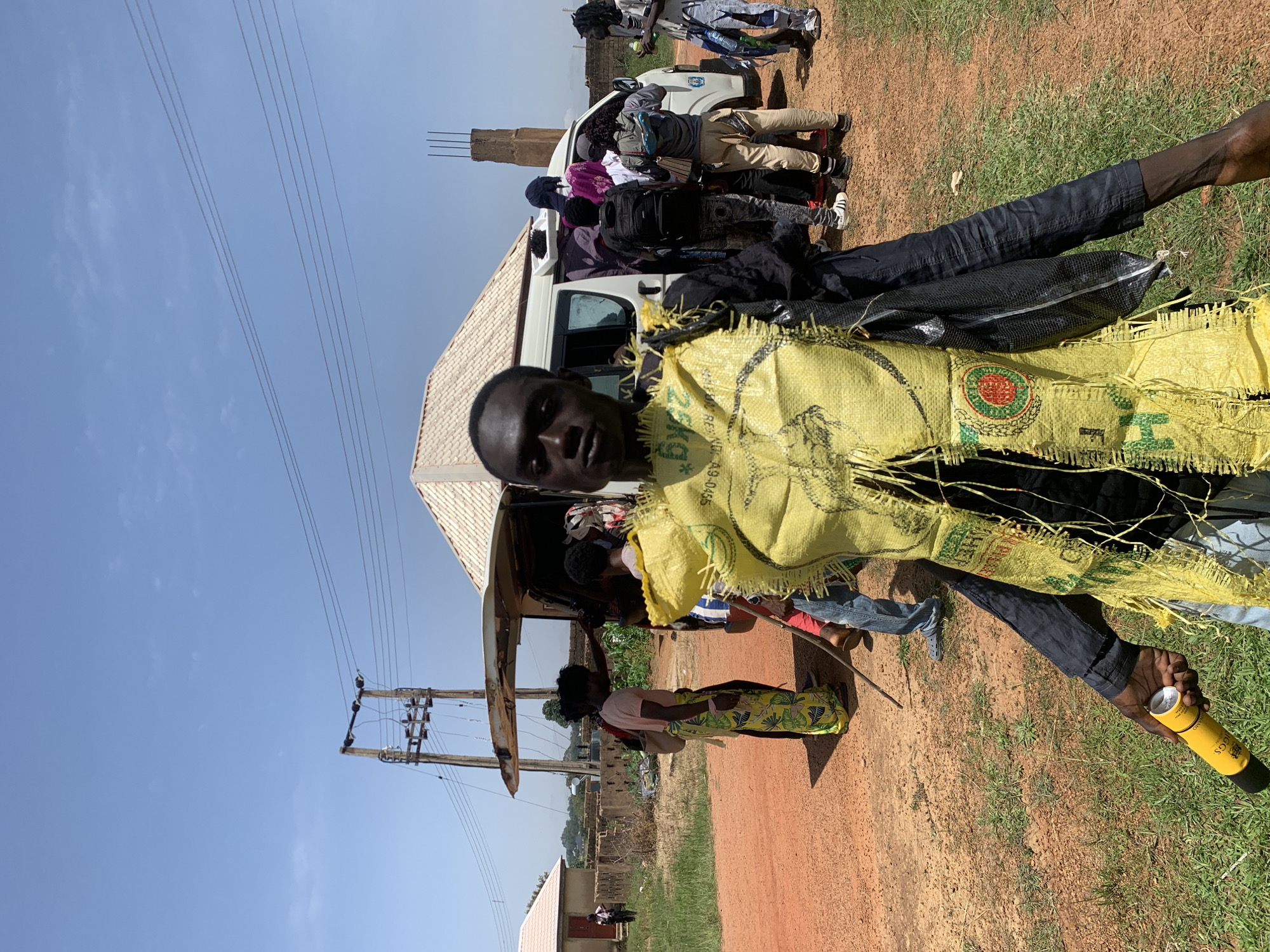 Costumed group gathering on a sunny morning in Gwafan, Nigeria