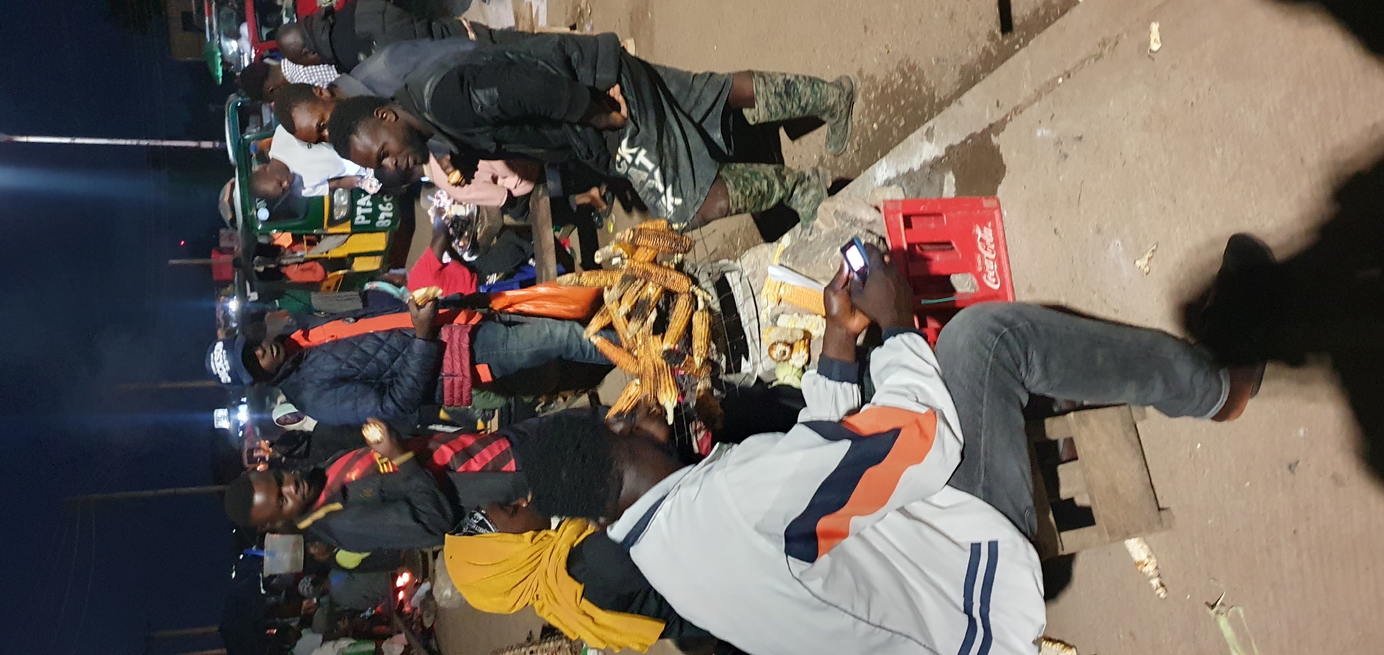 Night market vendors selling corn and fruit in Bukuru, Nigeria
