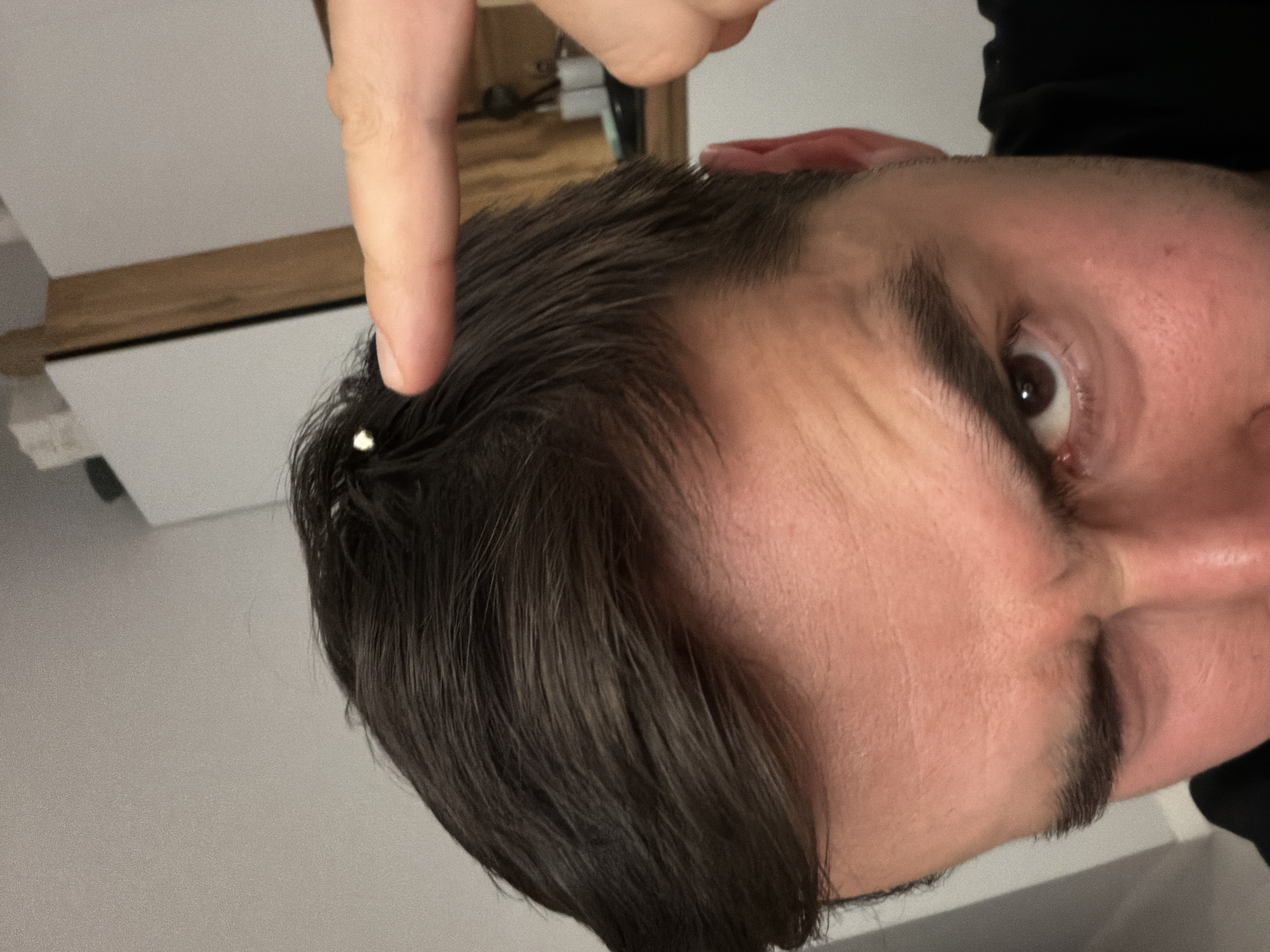 Close-up image captures finger pointing at face in Krasnoyarsk