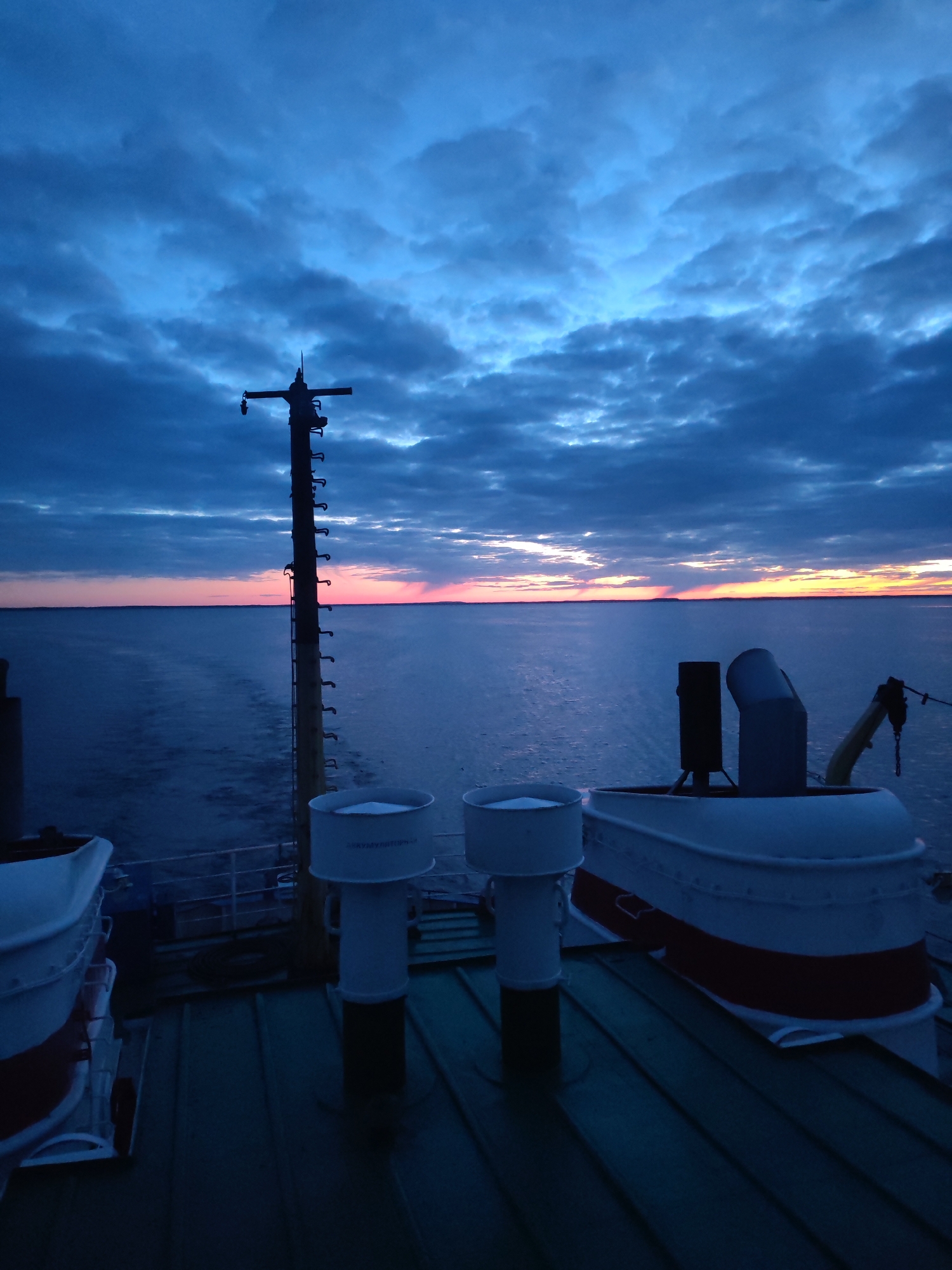 Dramatic sunrise captured from vessel deck in northern Russia
