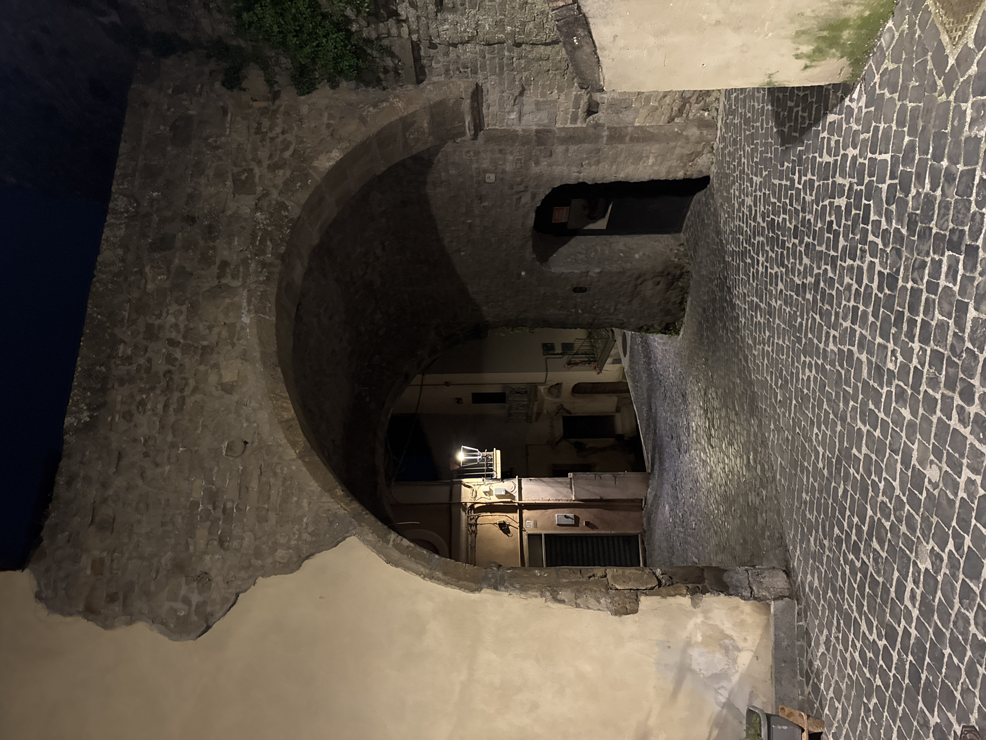 Nighttime scenes of historic cobblestone streets in Italian town