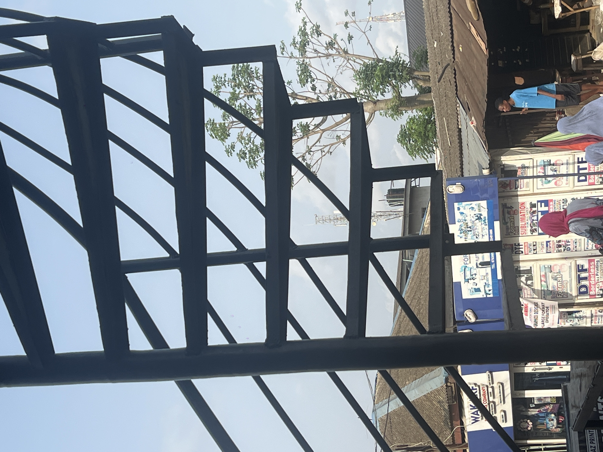 Street vendor carries food container in Lagos commercial district