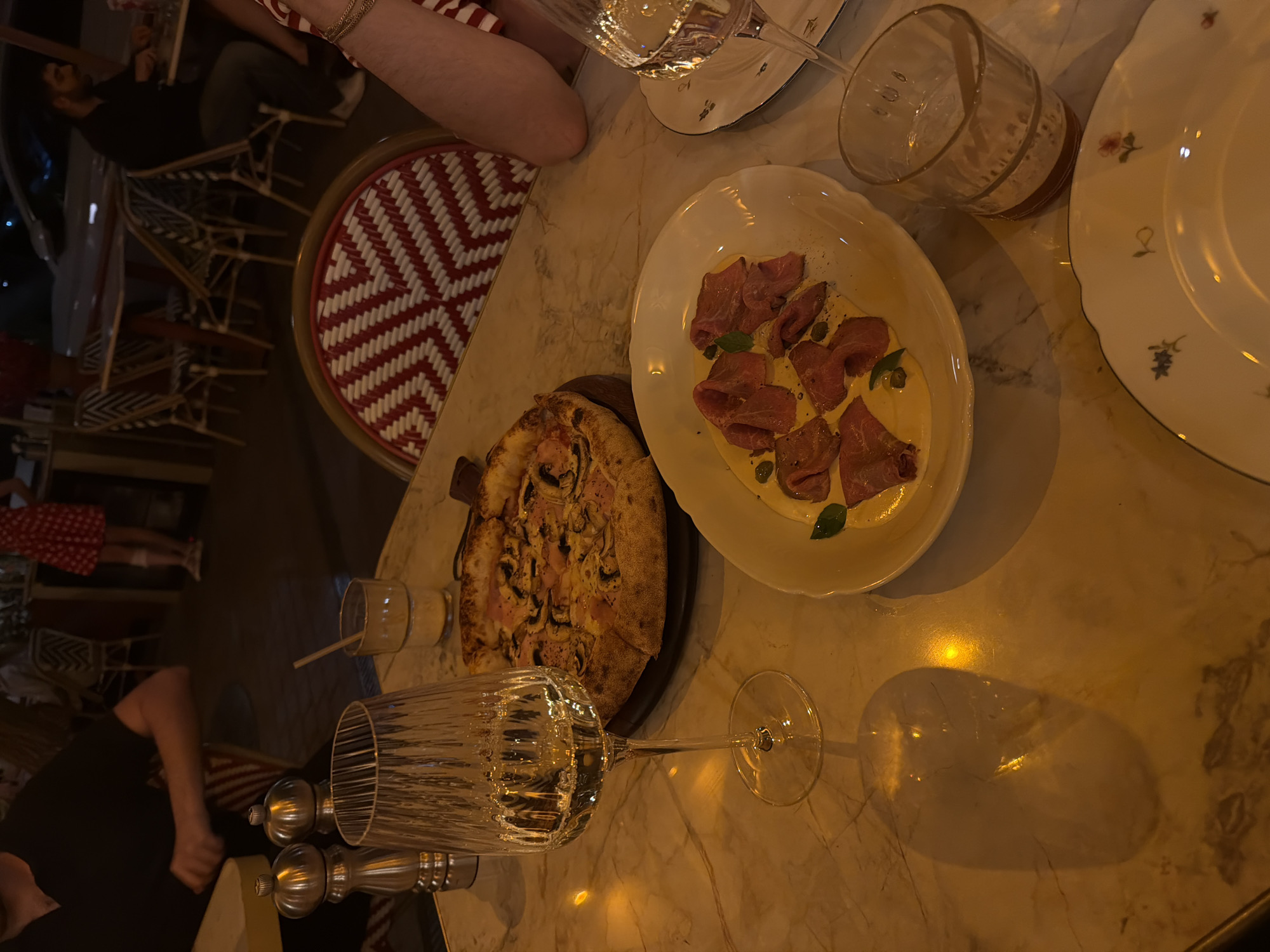 Wine, pizza, and charcuterie at a Yerevan outdoor table
