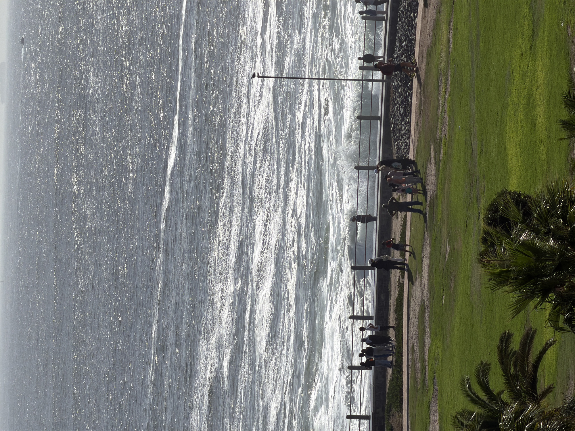 People gather at Sea Point Promenade overlooking choppy Atlantic
