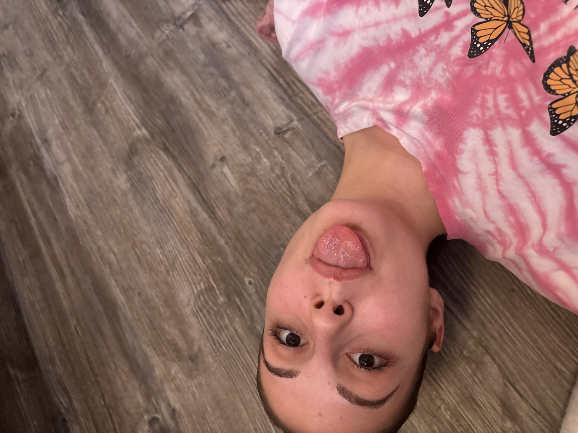 Young person takes playful floor selfies in Bulgaria