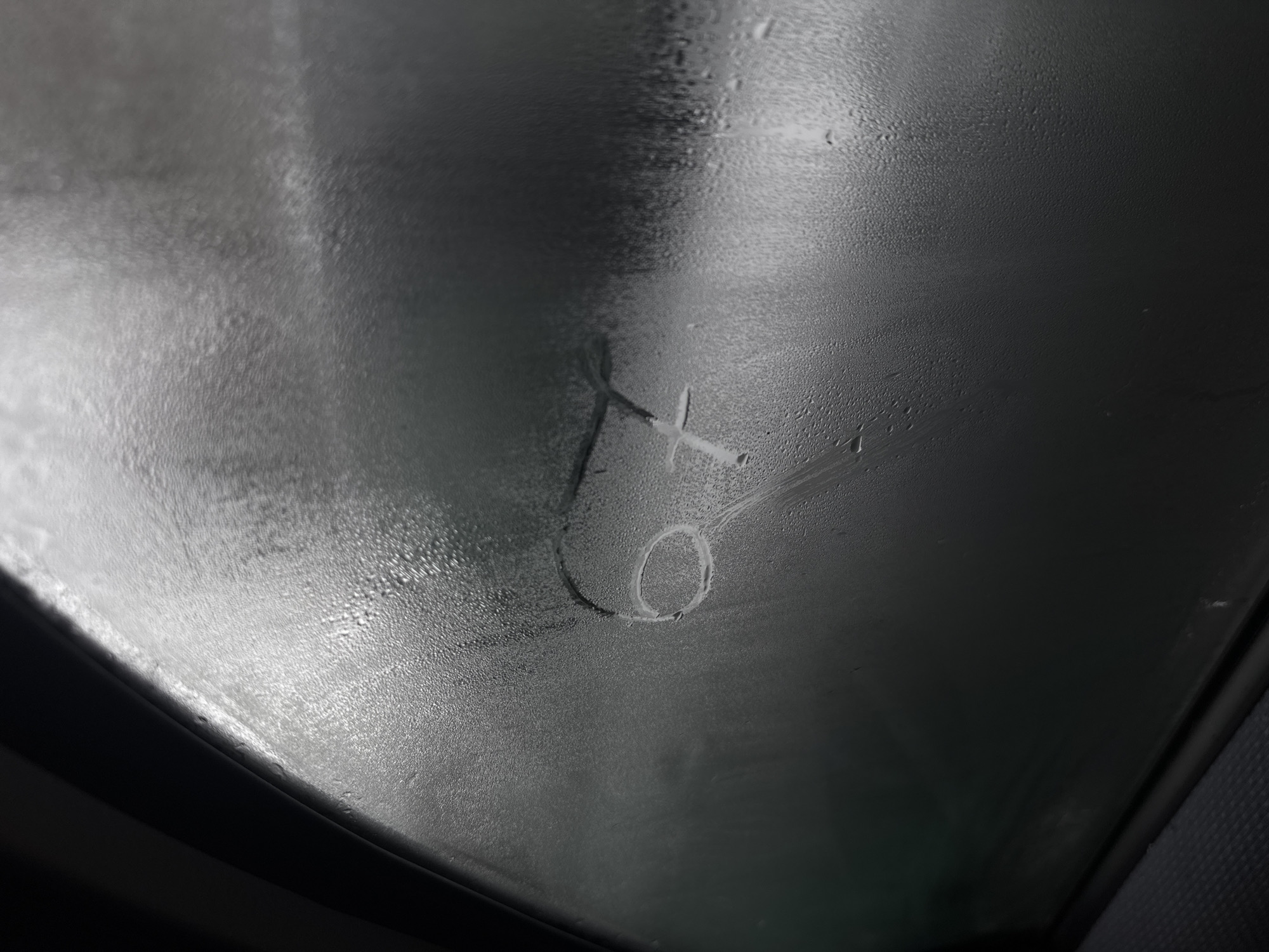 Person draws figure on fogged car window in Bulgaria