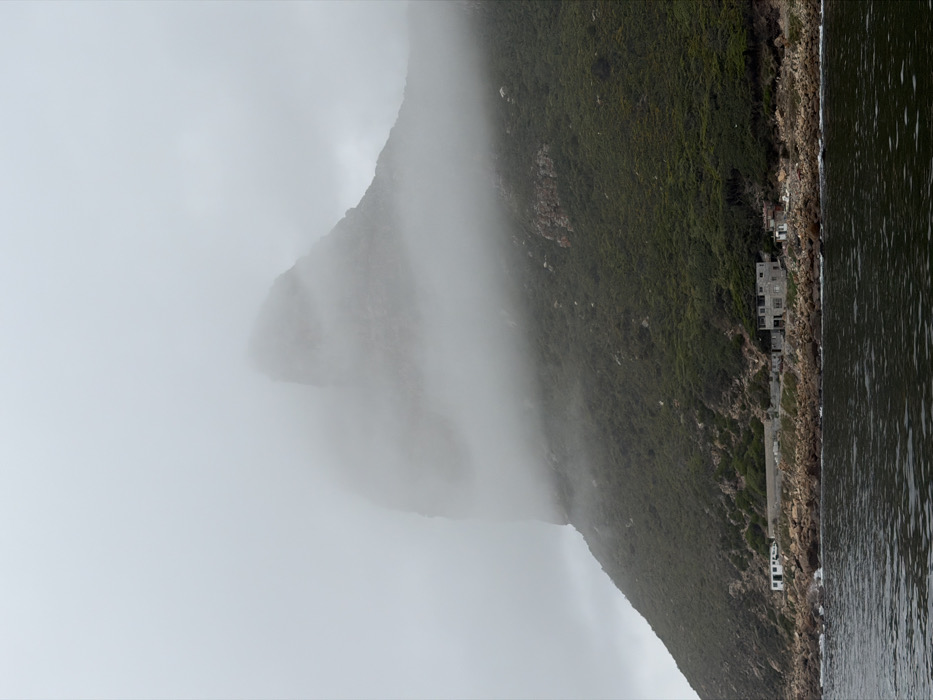 Dense fog shrouds Hout Bay mountain under overcast skies