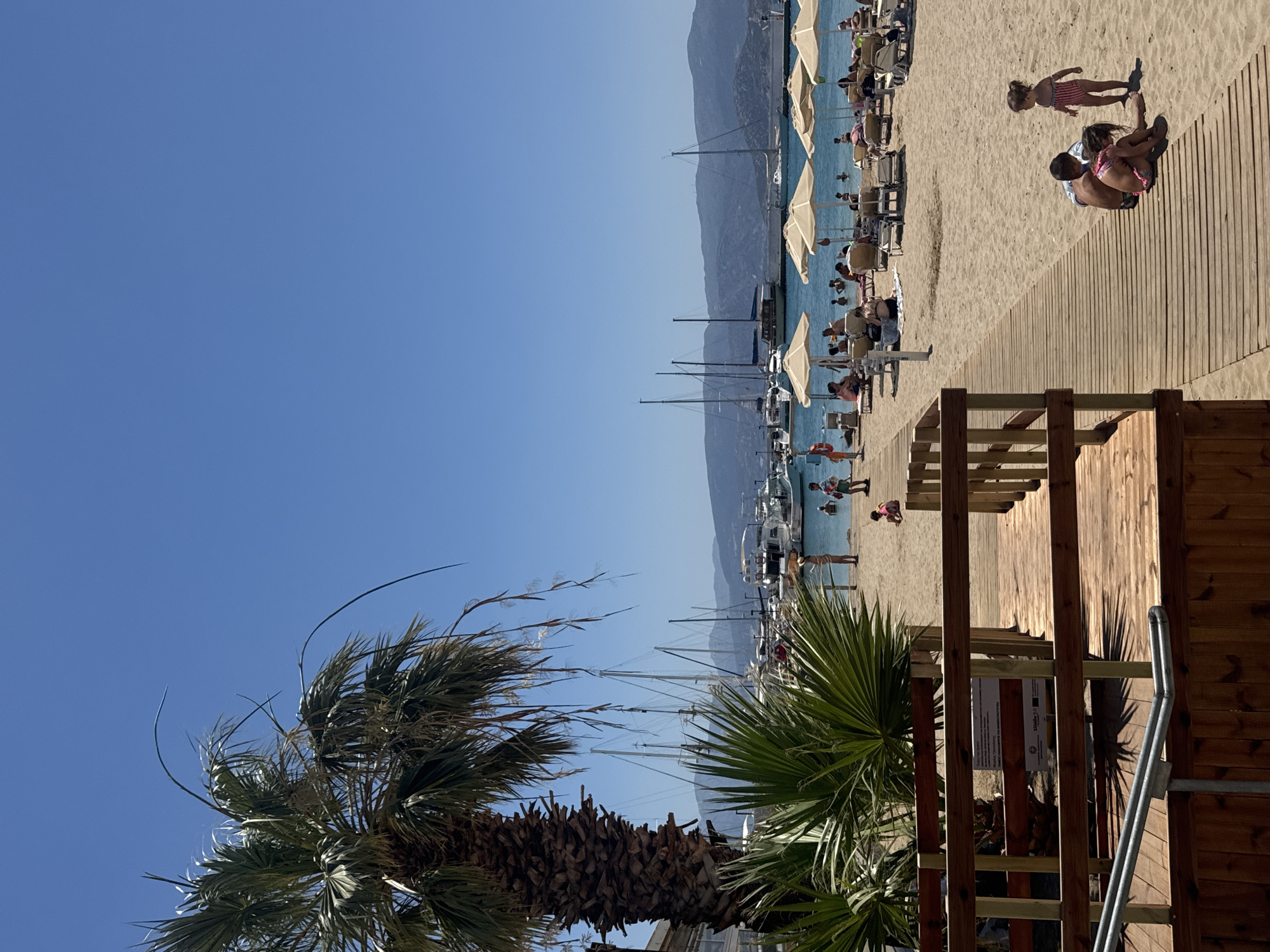Sunny morning around the harbor and beach of Agios Nikolaos