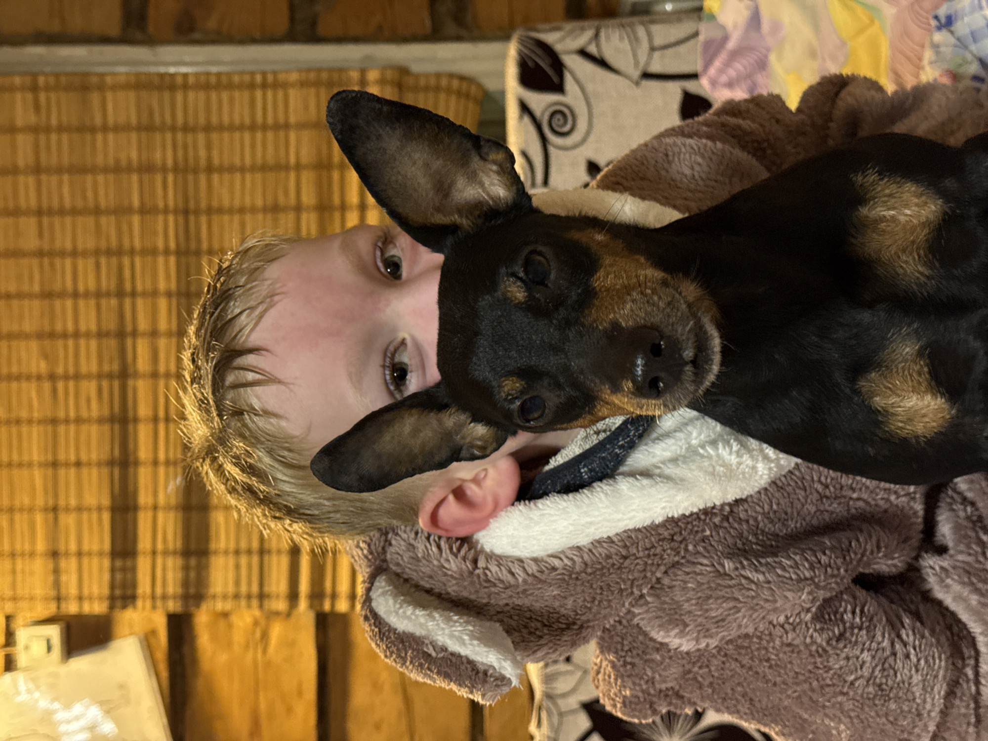 Child and dog share warm moment in Rosstani home