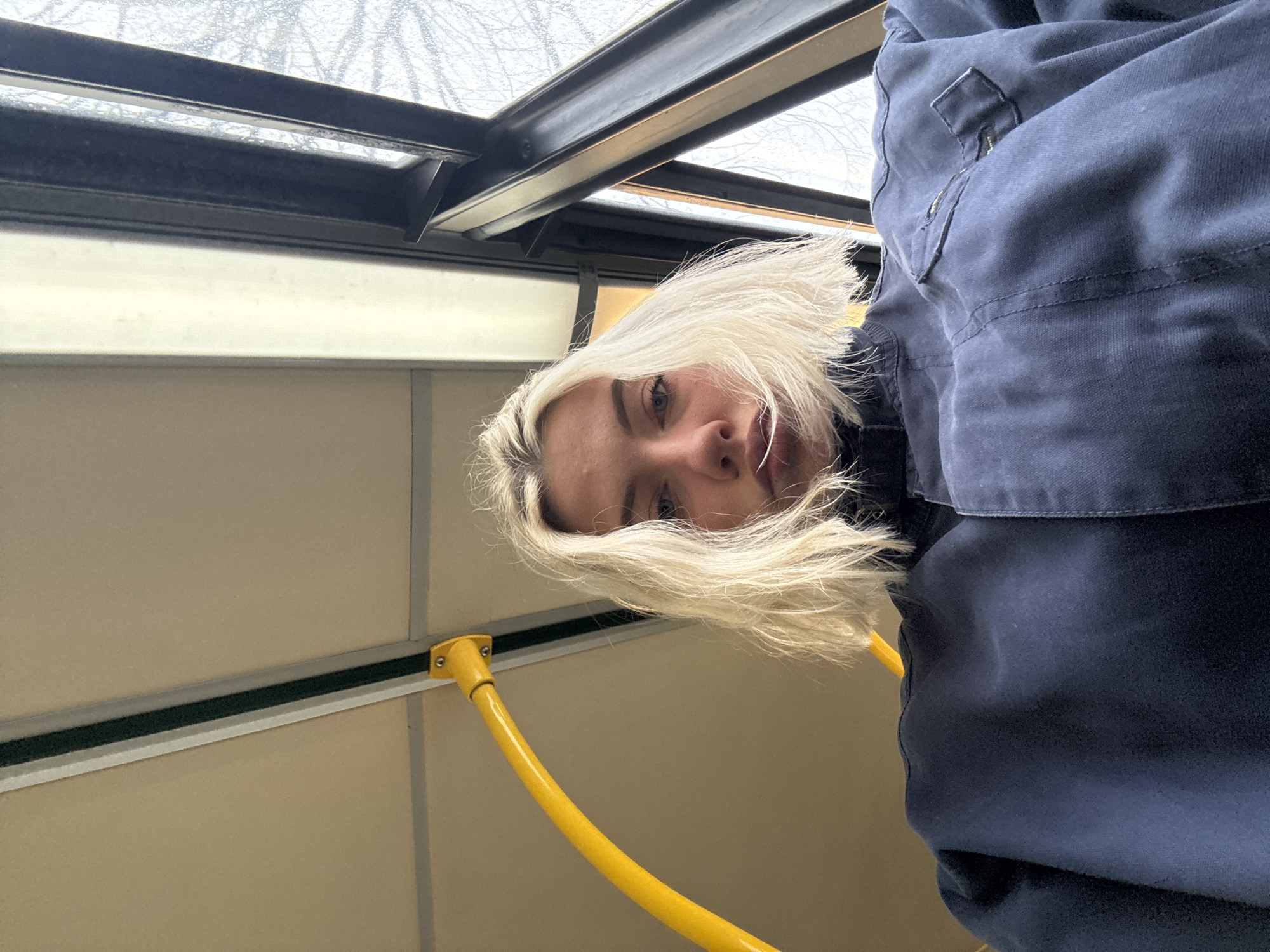 Person photographed from low angle in Manchester morning