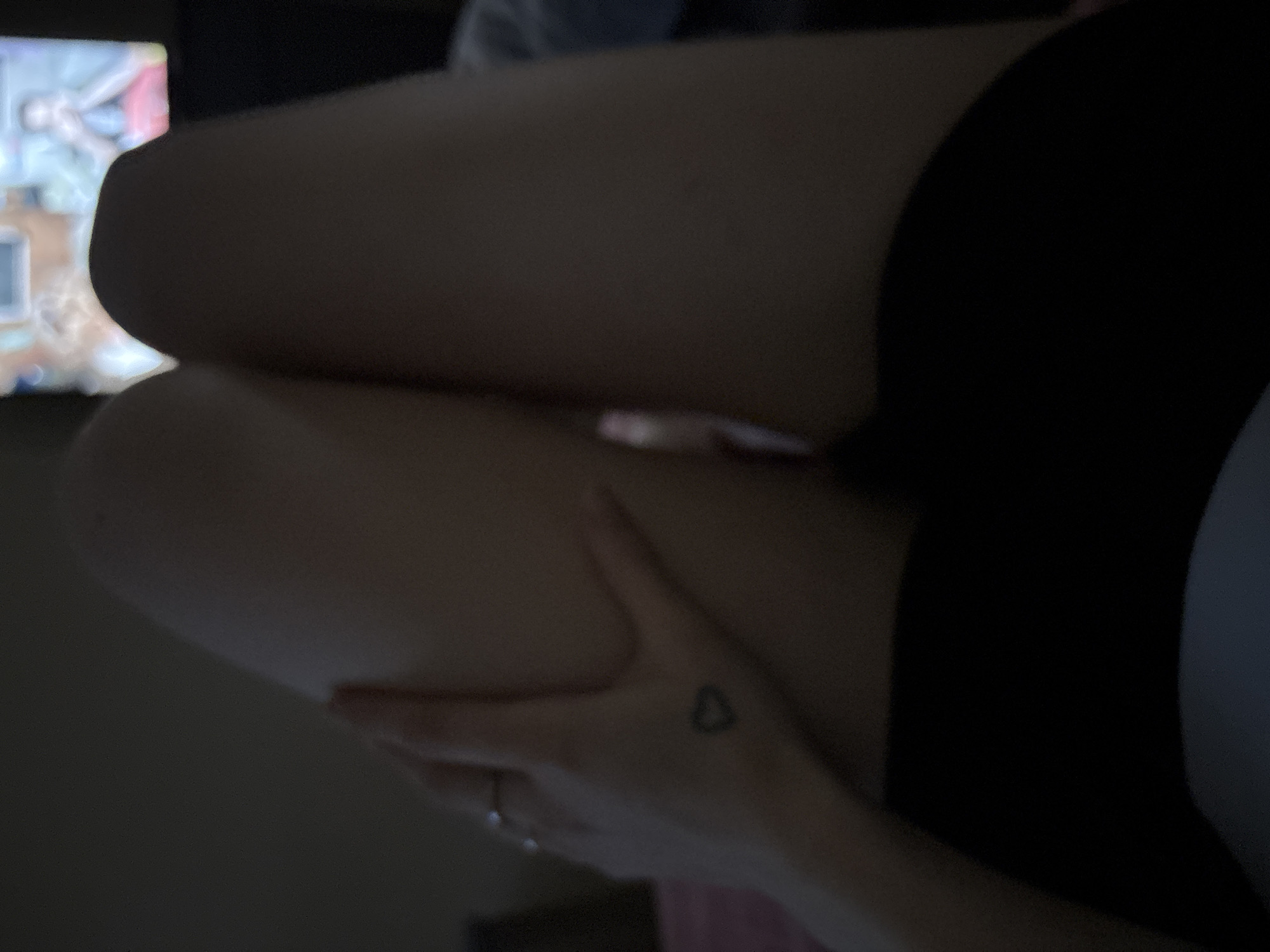Cat napping, legs up, low light — a chill night in.