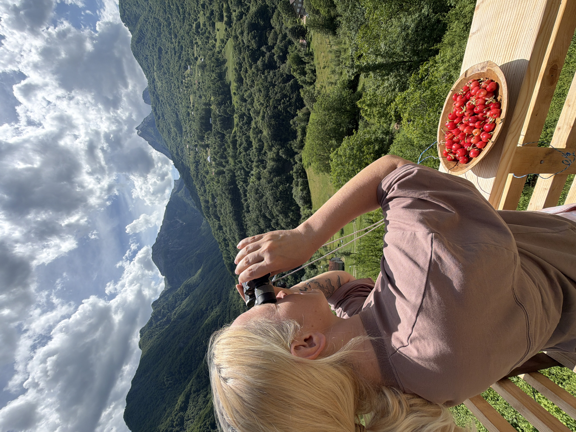 Woman enjoys mountain view from balcony in Montenegro village