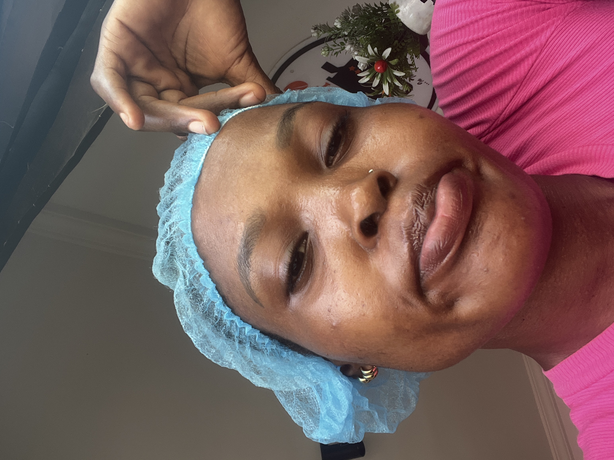 Medical worker adjusts surgical cap in Lekki, Nigeria