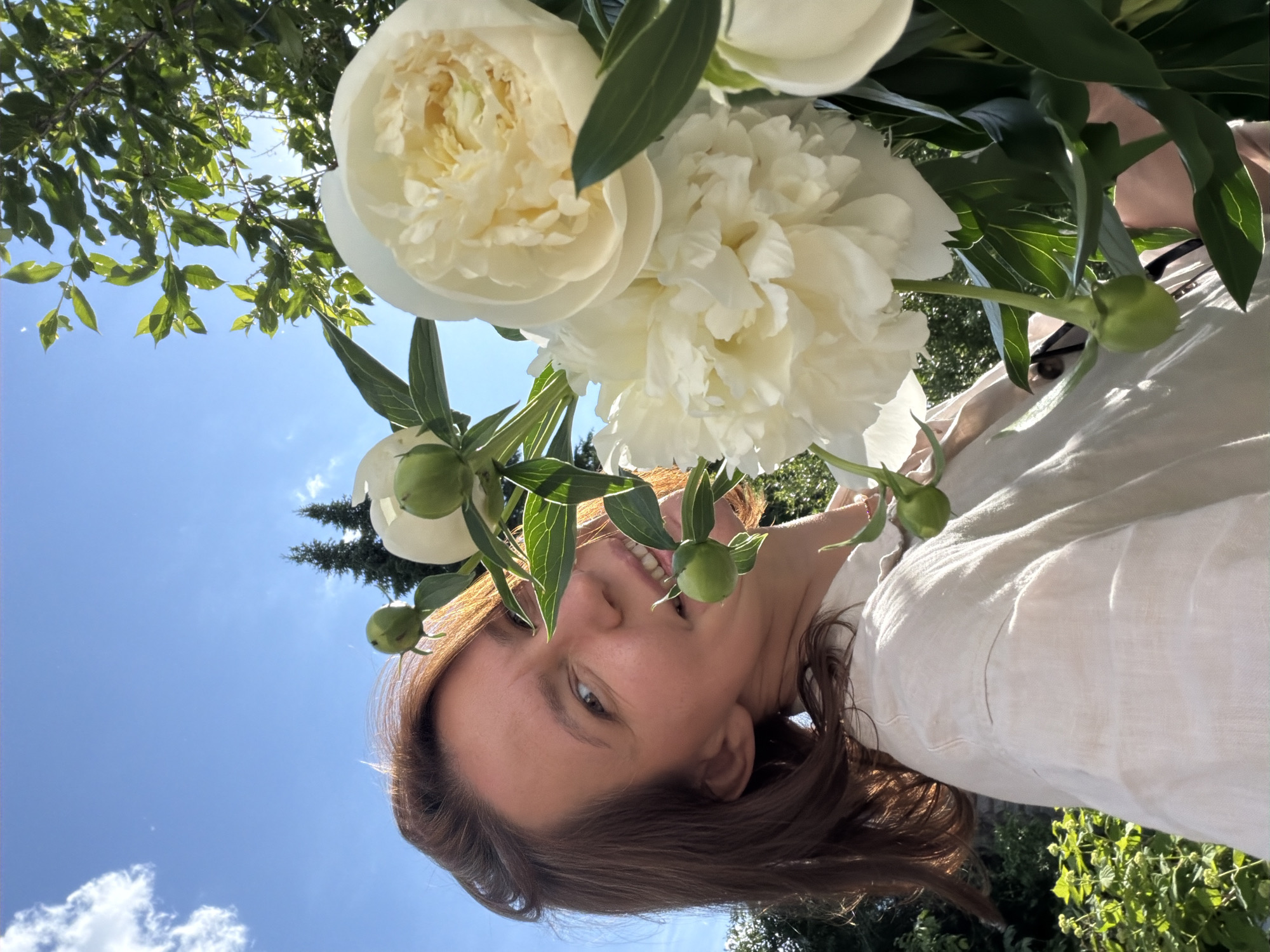 Woman photographed in blooming garden in Прикамский, Russia