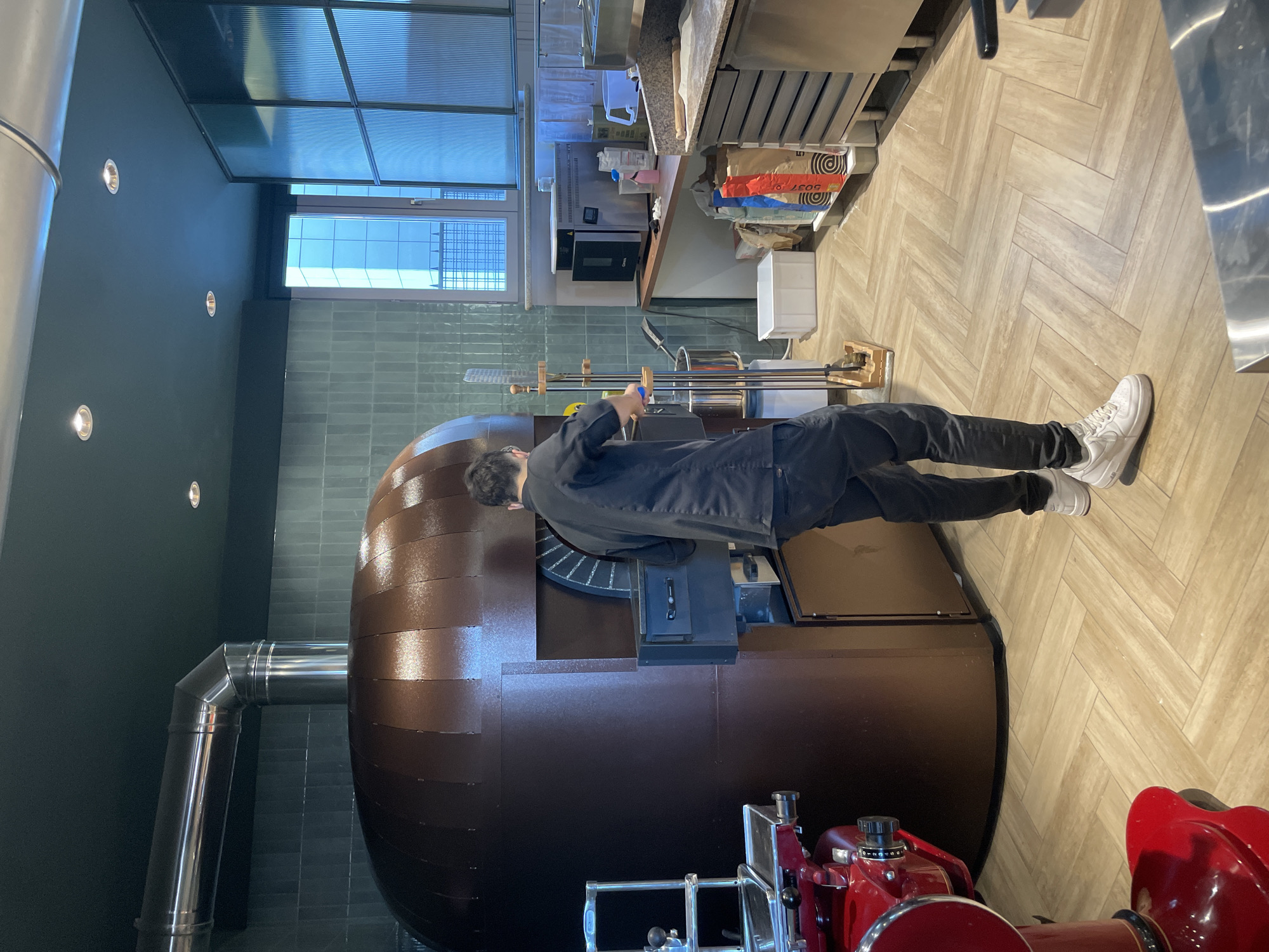 Pizza maker works traditional oven in Busto Arsizio restaurant