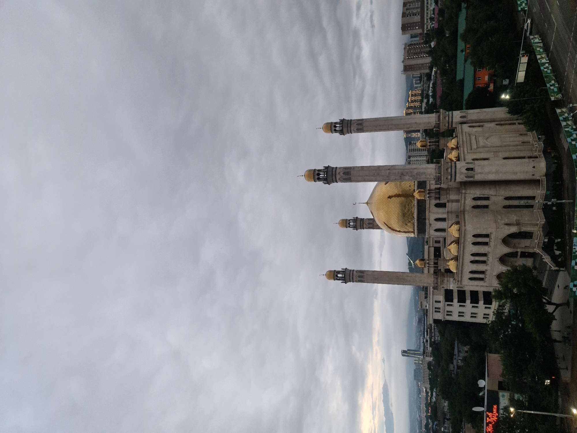 Almaty at dusk: the Central Mosque and city under heavy cloud