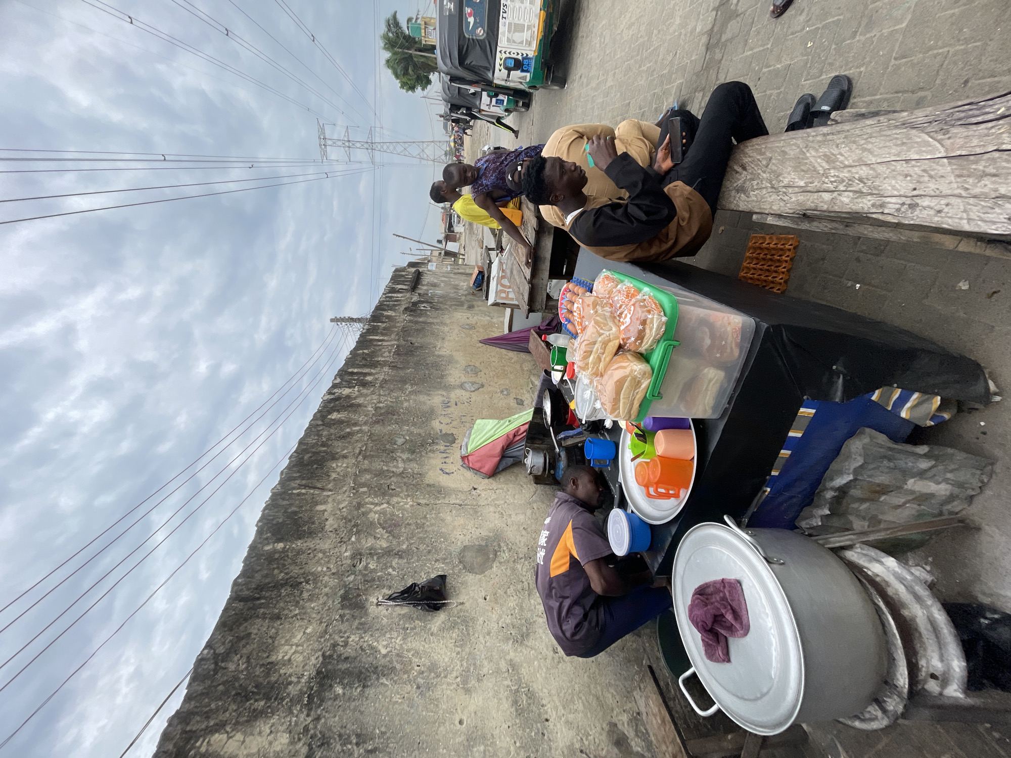Morning street food vendors serve customers in Ado, Nigeria