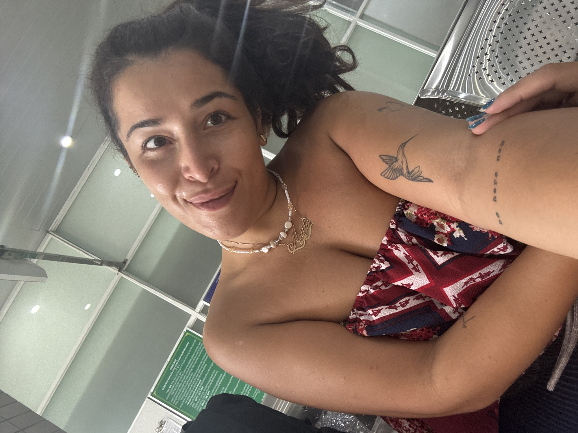 Indoor selfie in Ben Cau, patriotic-patterned top and pearls