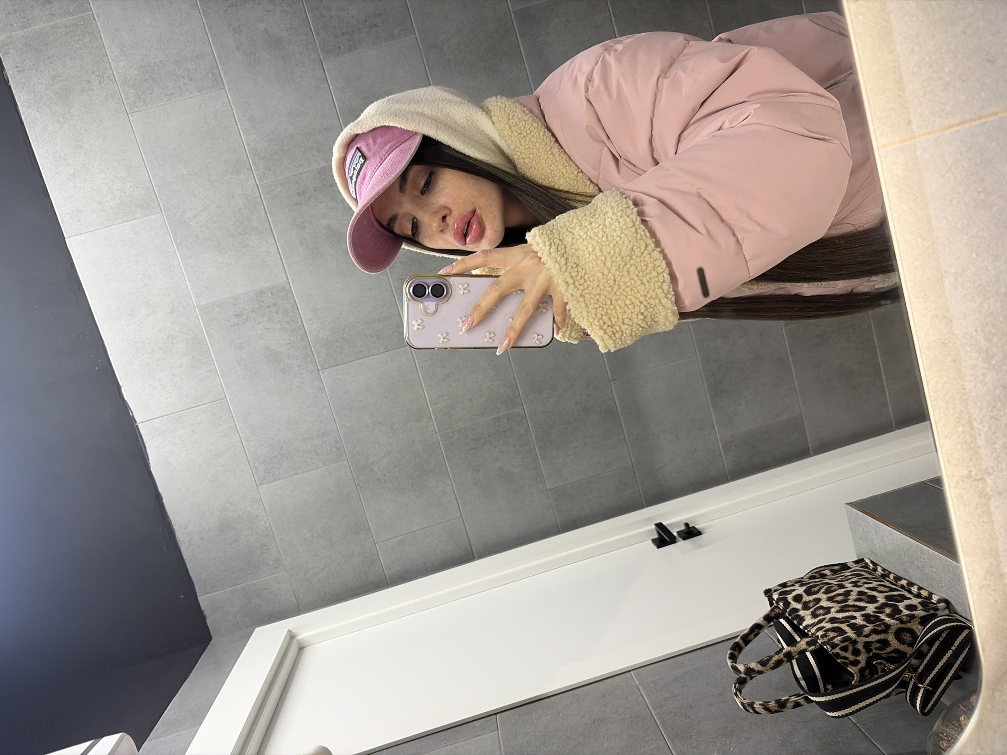 Woman takes bathroom selfies in pink outfit, Saint Petersburg