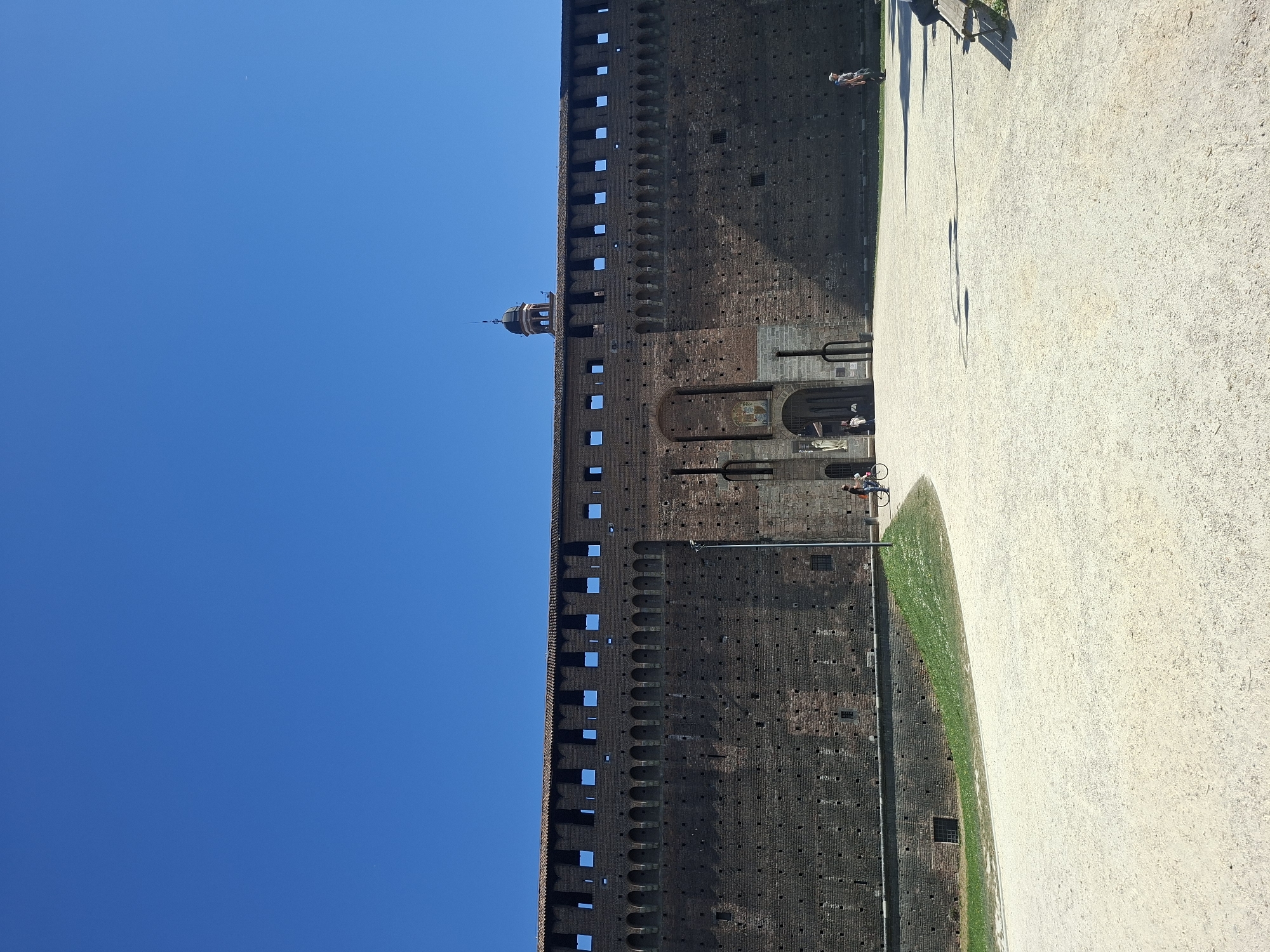 Tourists visit Milan's Sforza Castle on sunny April morning