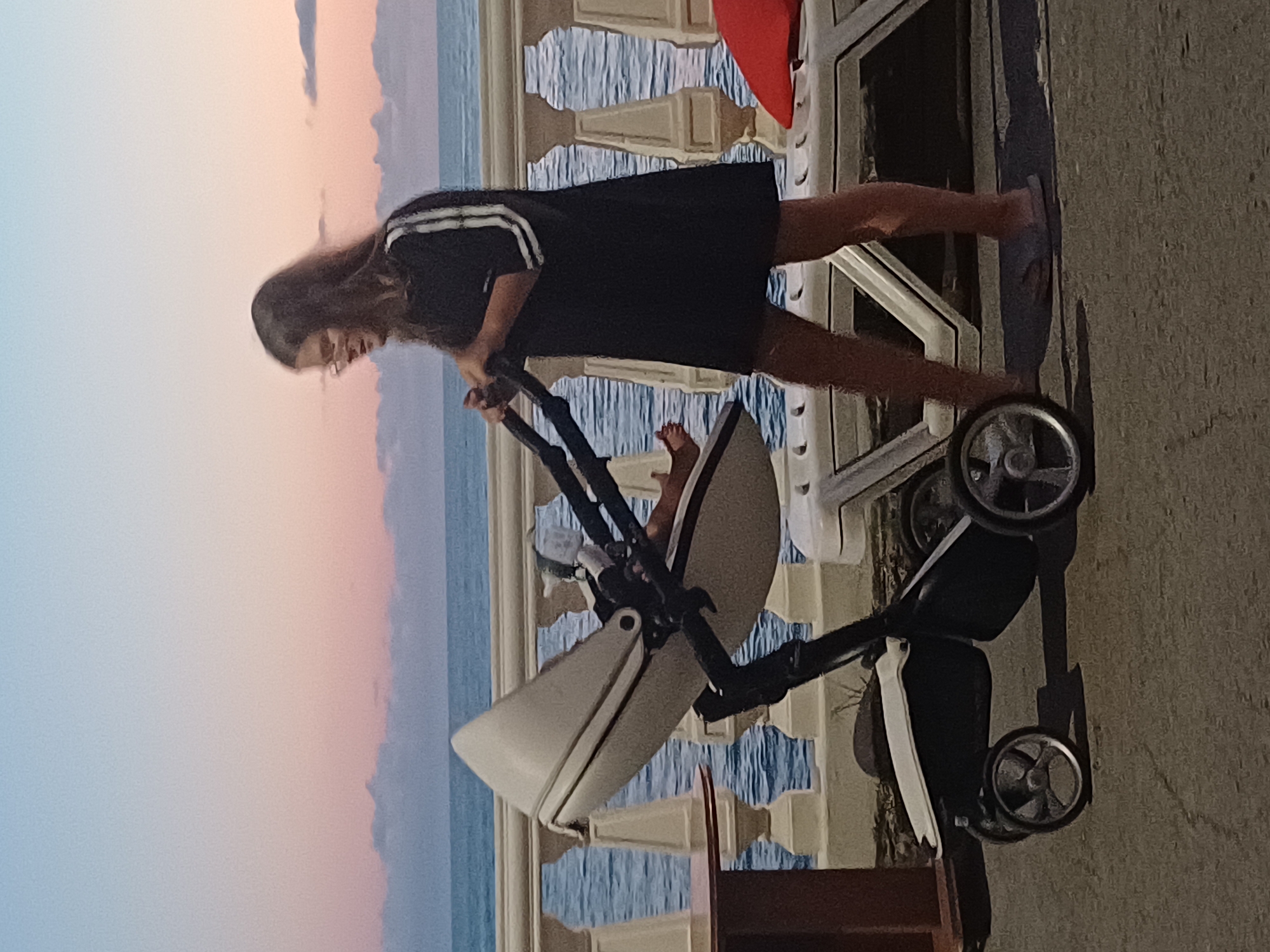 Sochi waterfront promenade at sunset, people watching the Black Sea