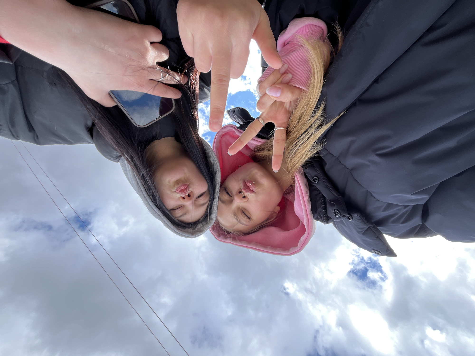 Friends take early morning selfies on bridge in Chaikovsky