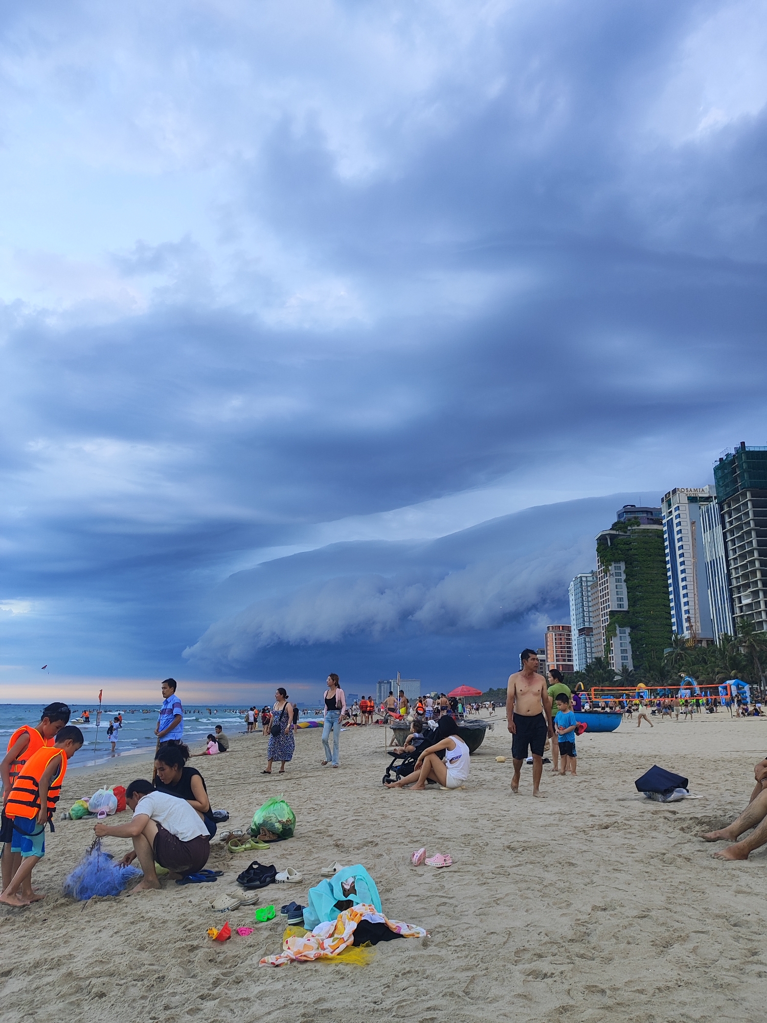 Storm clouds gather over Da Nang beach amid ongoing activities