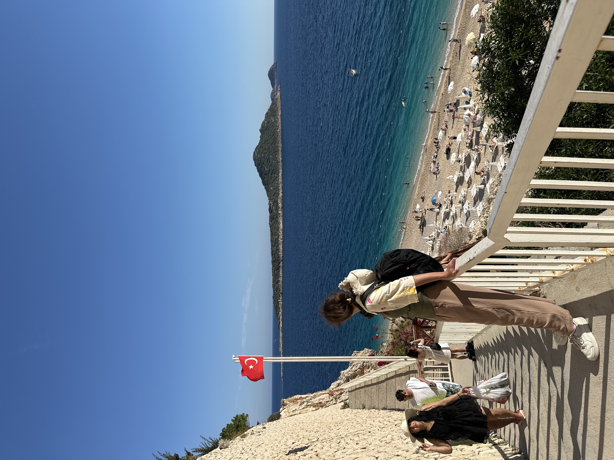 Tourists capture scenic Mediterranean coastline views in Kaş, Turkey
