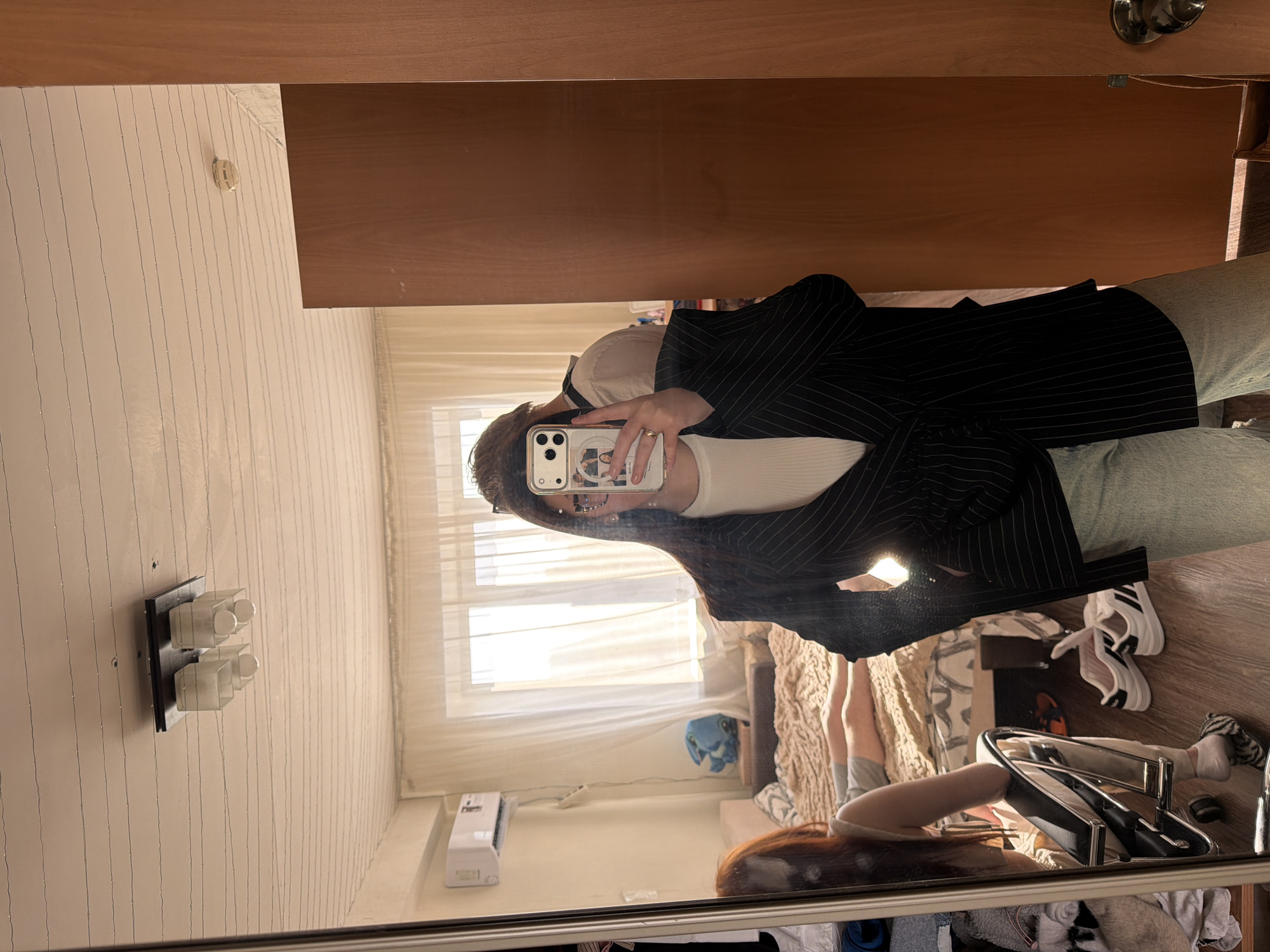 Person takes mirror selfie in Izhevsk bedroom