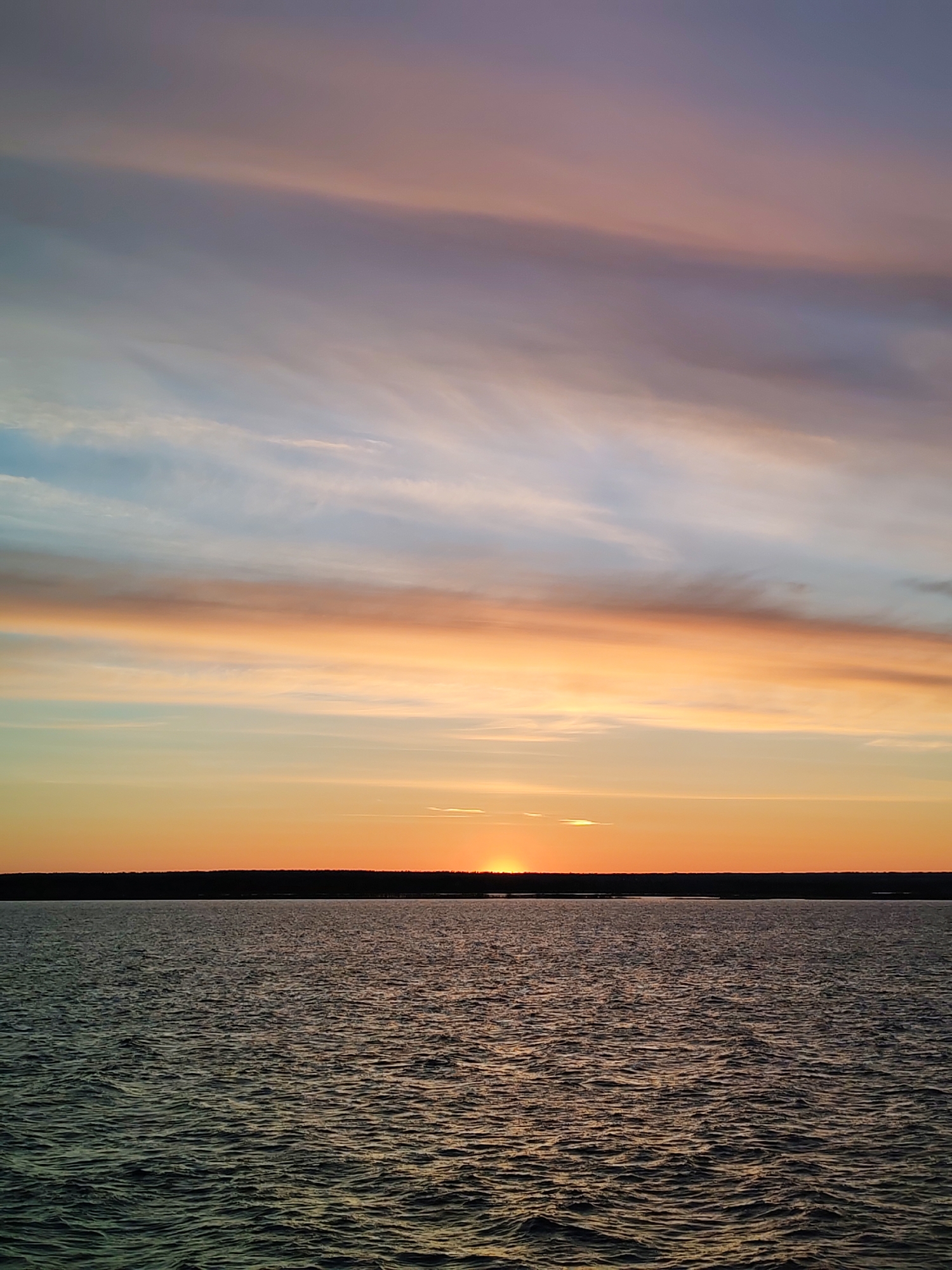 Sunset observed over water near Vasil'evskoe, Russia