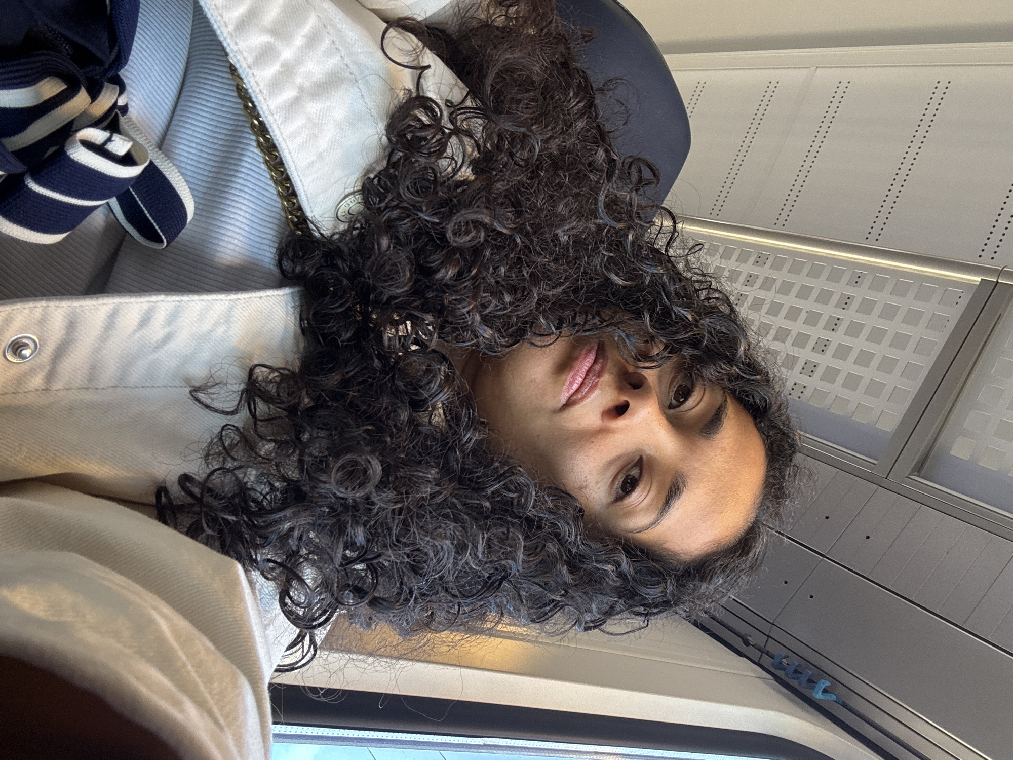 Person with curly hair photographed indoors in Sprinkange, Luxembourg