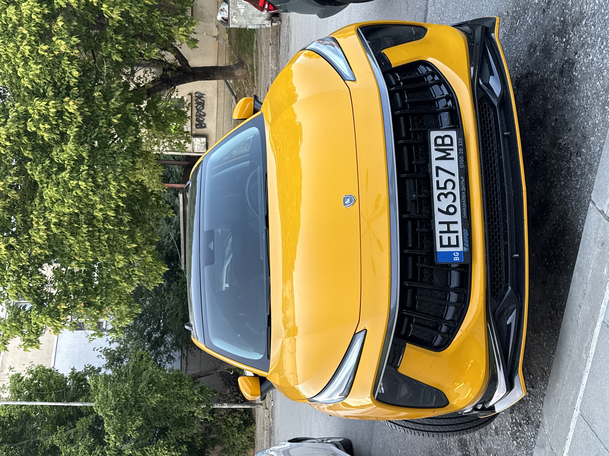 Yellow SUV parked outside graffiti-covered building in Pleven