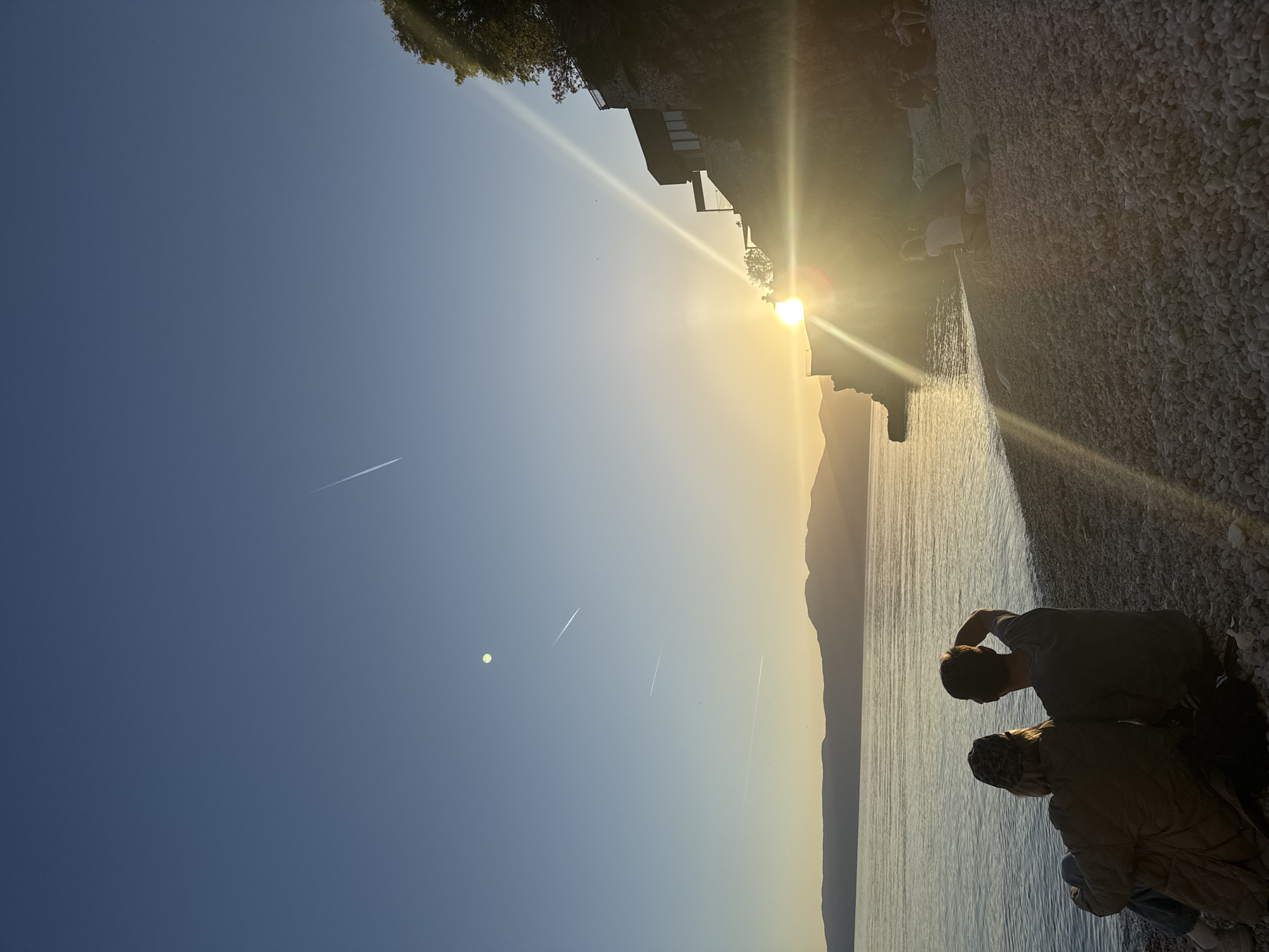 Two people enjoy sunset on Rijeka beach