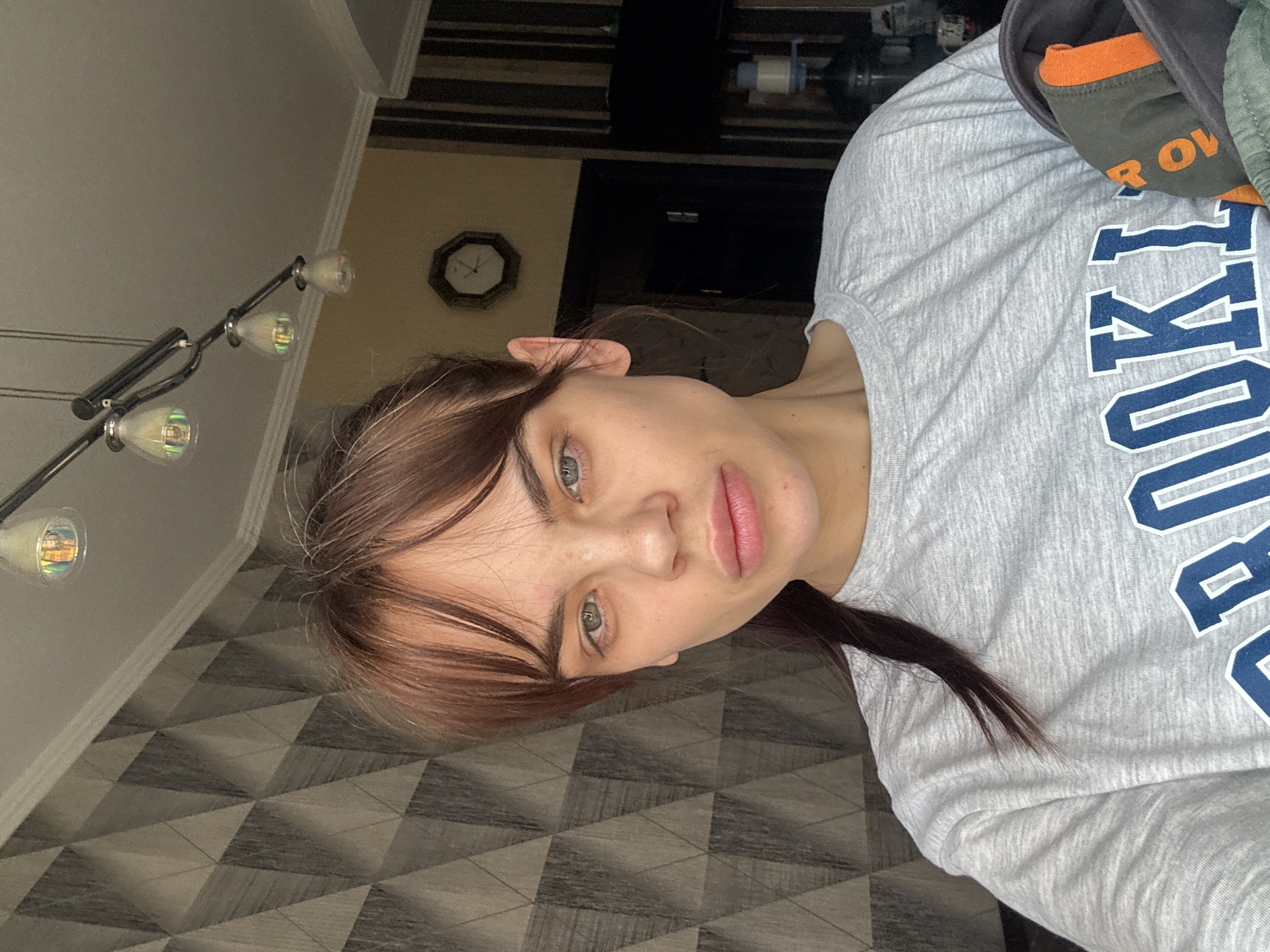 Woman in Brooklyn shirt photographed in Rostov-on-Don apartment