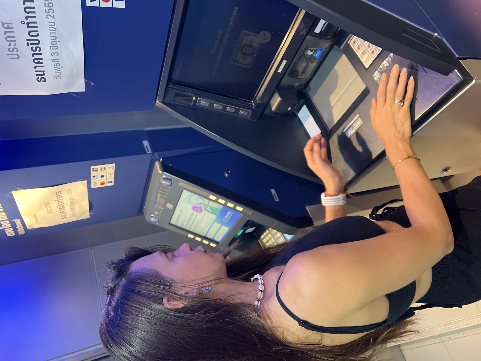 Woman makes cash deposit at Bangkok Bank ATM Thailand