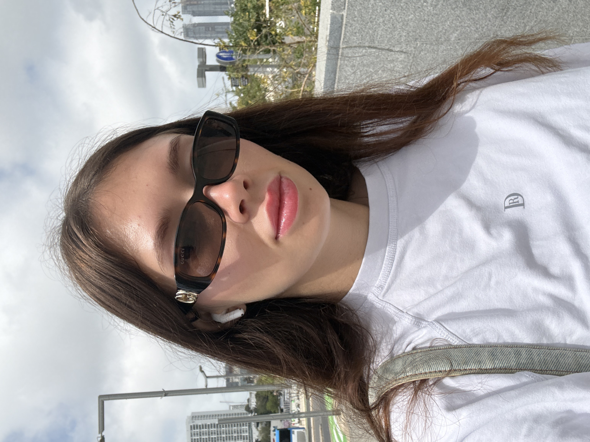 Woman takes selfie in designer accessories in Tel Aviv
