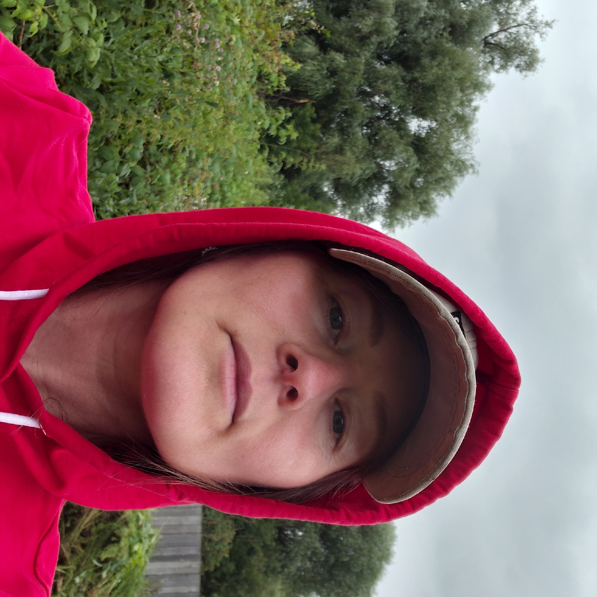 Morning garden walk: gloved hands, raspberries, and overcast skies