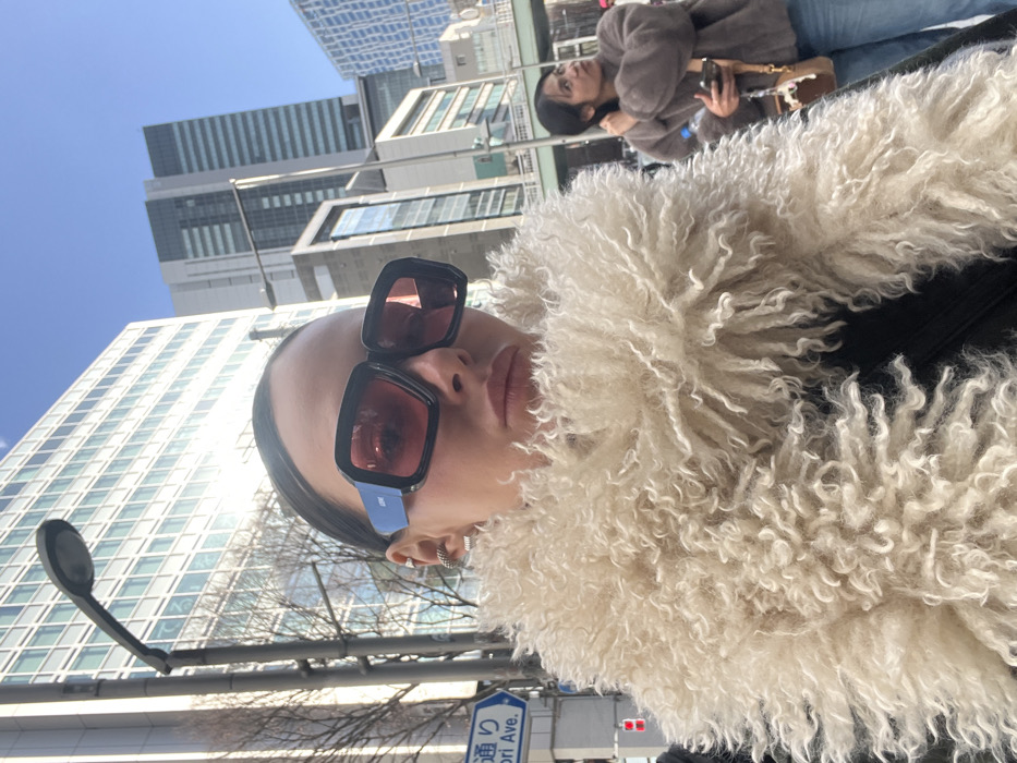 Woman takes selfie in early morning Shibuya near Miyashita Park