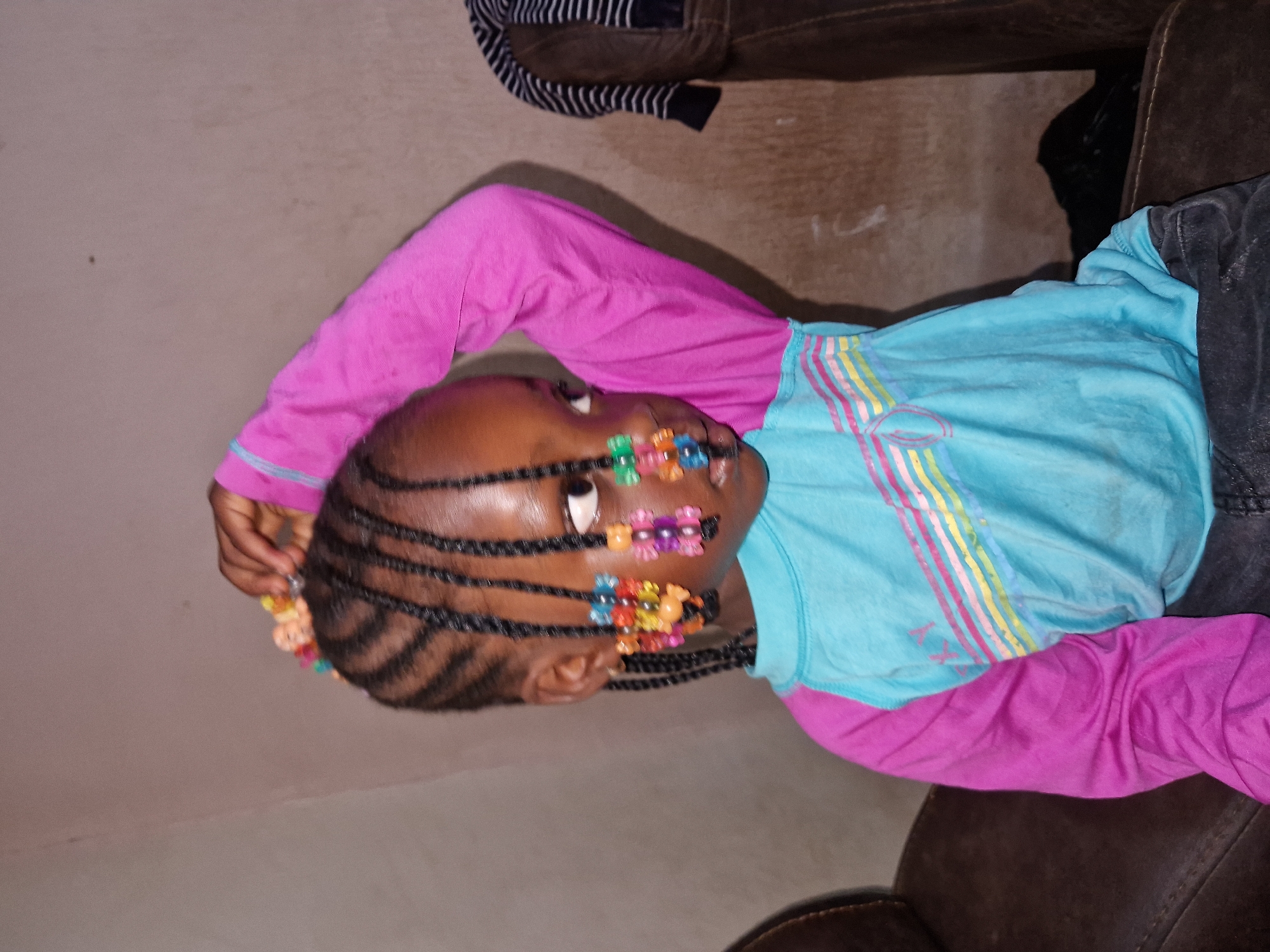 Casual indoor moments with colorful braids and Naira in hand