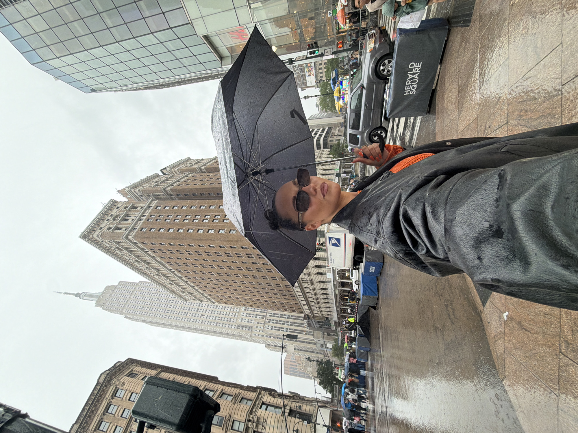 Person with umbrella spotted in rain near Empire State Building