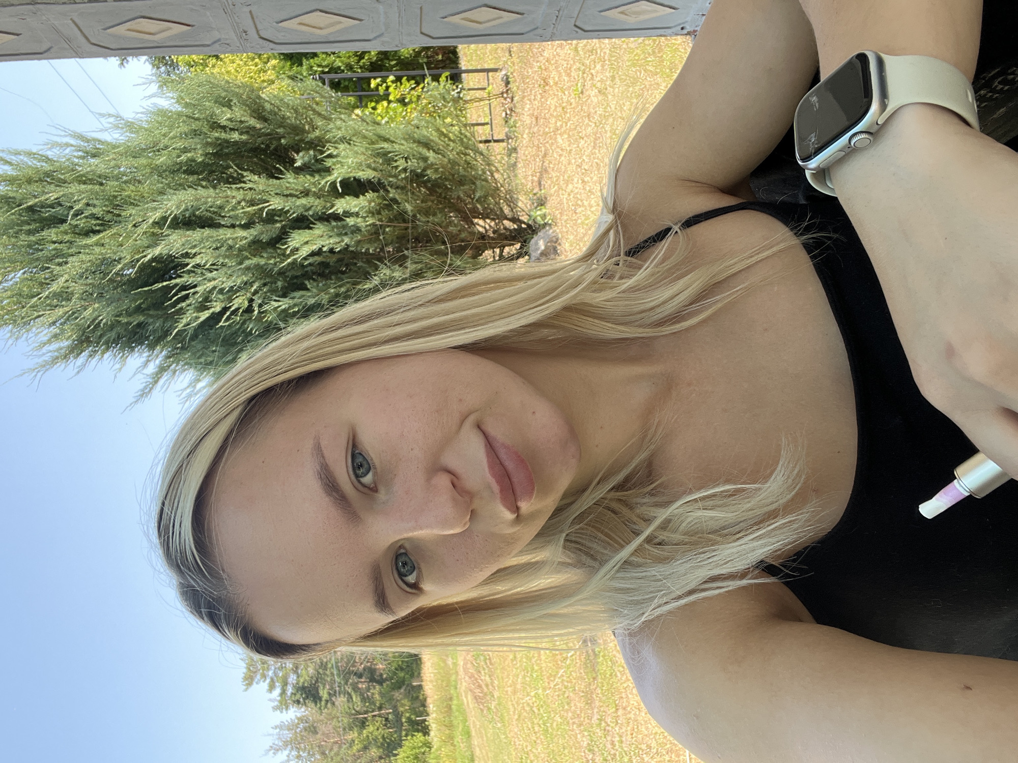 Outdoor selfie session near a decorative garden setting
