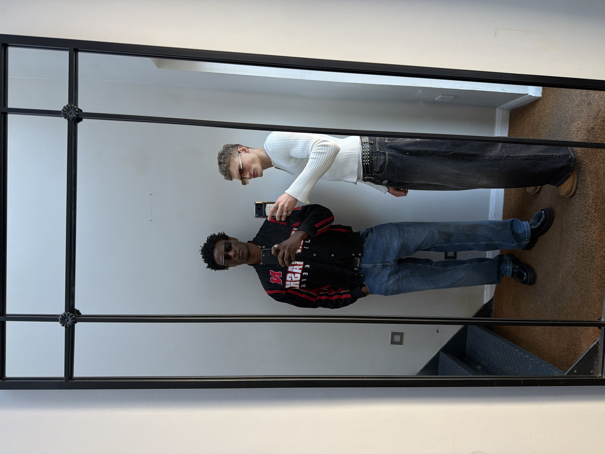Two people take mirror selfie in London