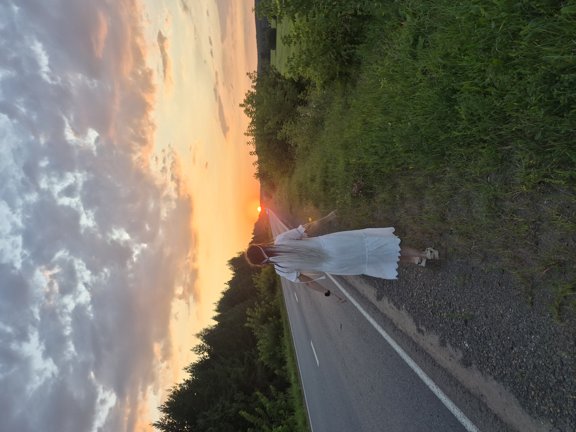 White dress, braided hair, golden hour on a Russian country road