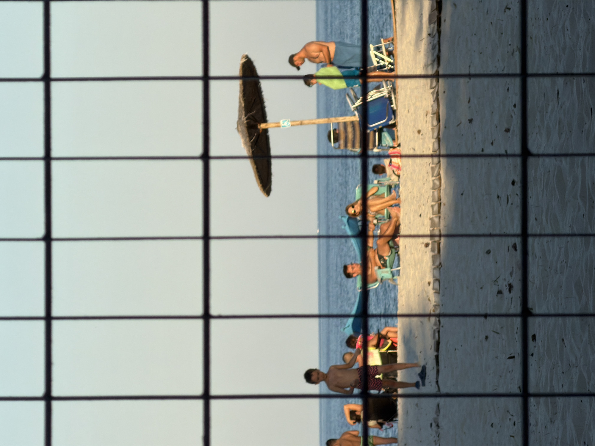 Casual beach camp at Golden Beach, Greece, through sunset.