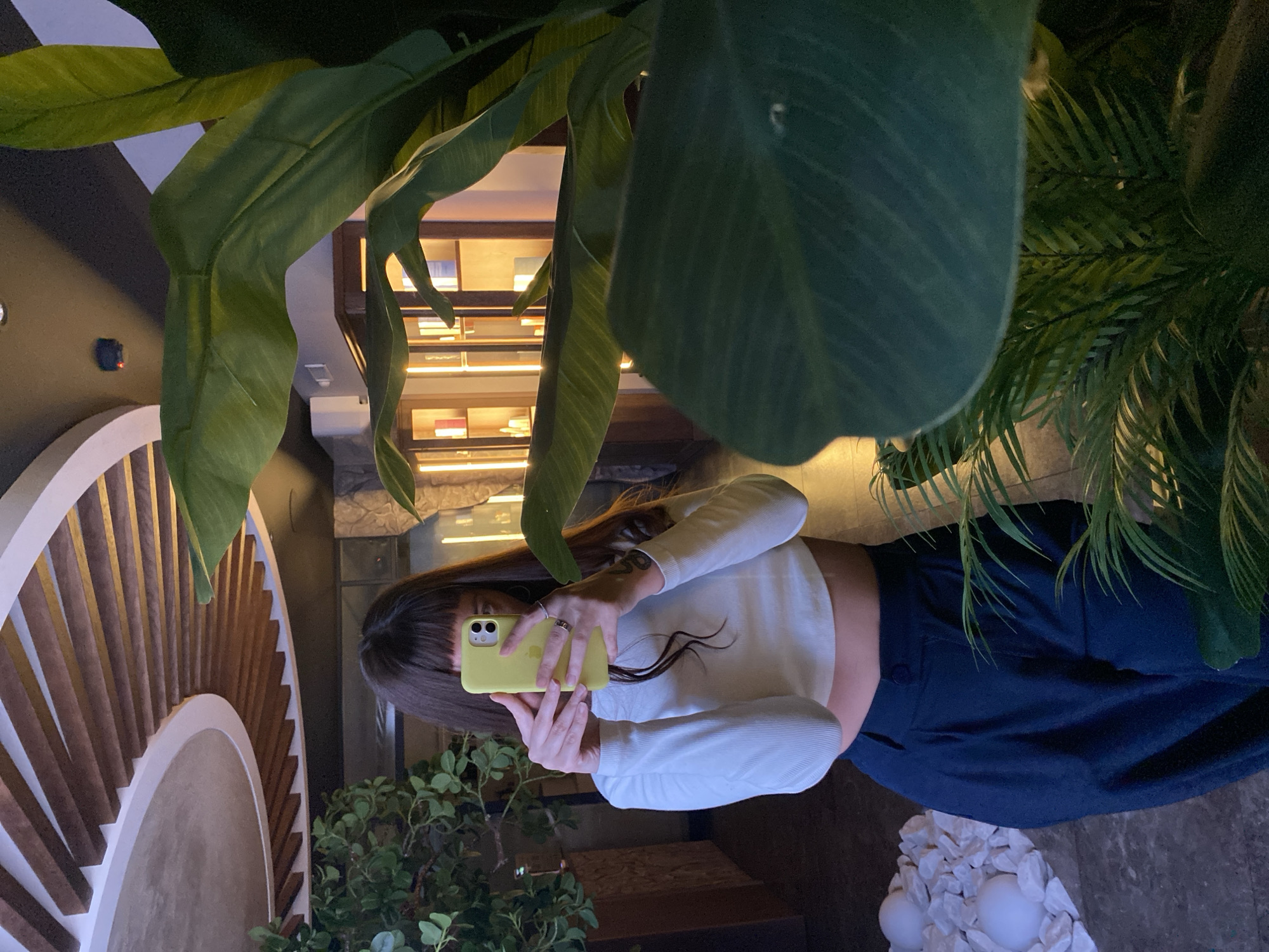 Mirror selfie session in a Votkinsk interior, yellow phone in hand.