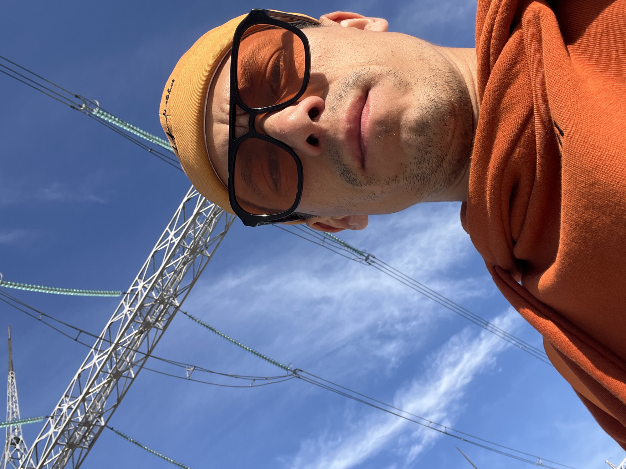 Person photographed from below against blue sky in Chaikovsky