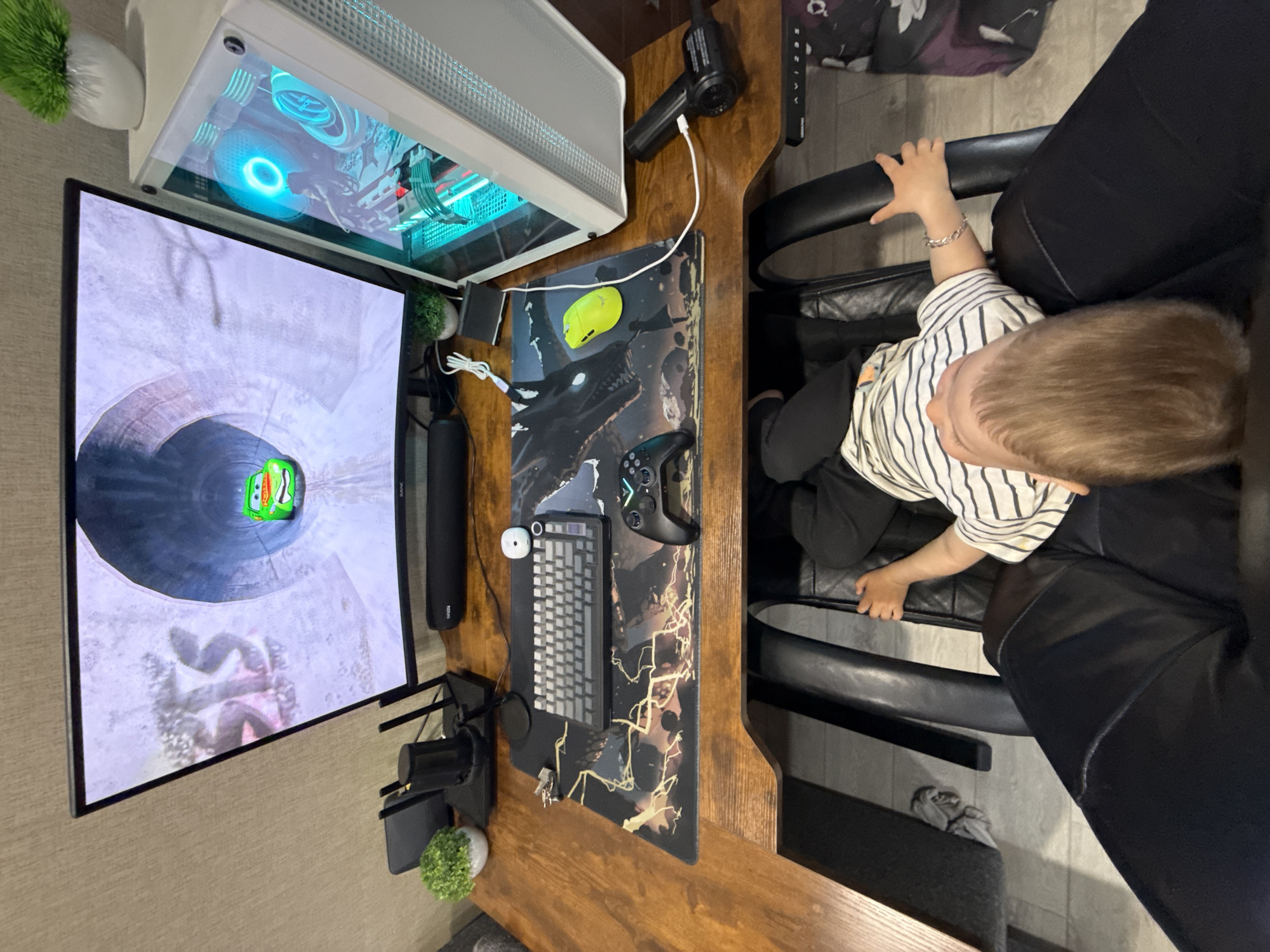 Toddler sits at home office desk in Rusanovo